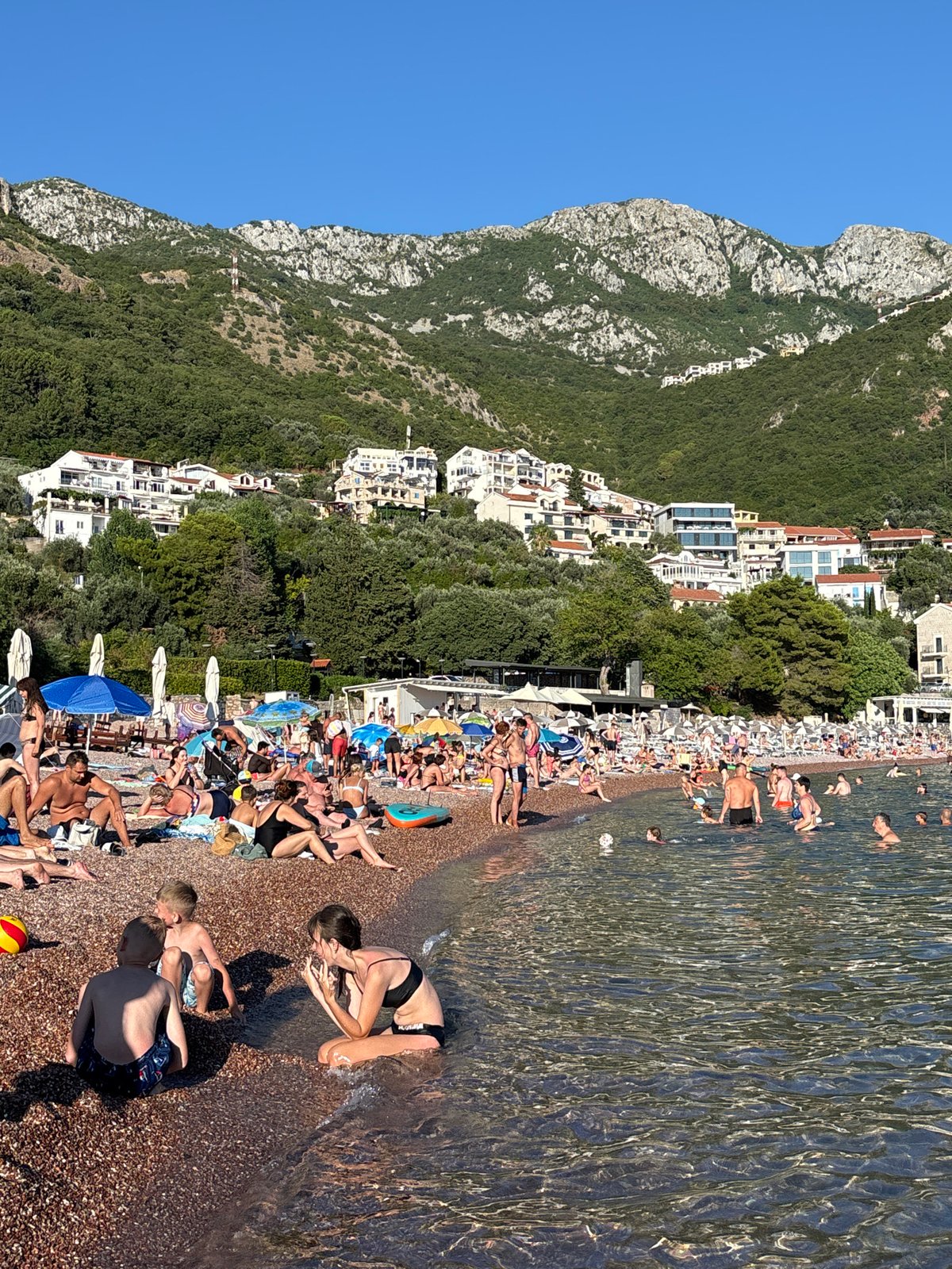Busy summer afternoon on the beach at Sveti Stefan, Montenegro