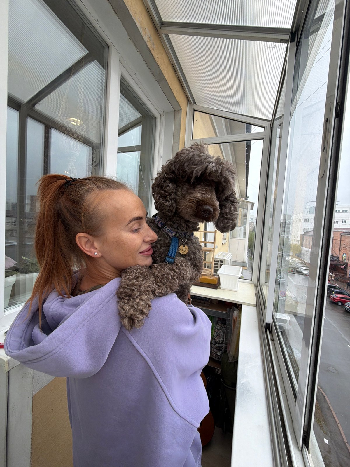 Woman and poodle spend rainy morning in Krasnoyarsk