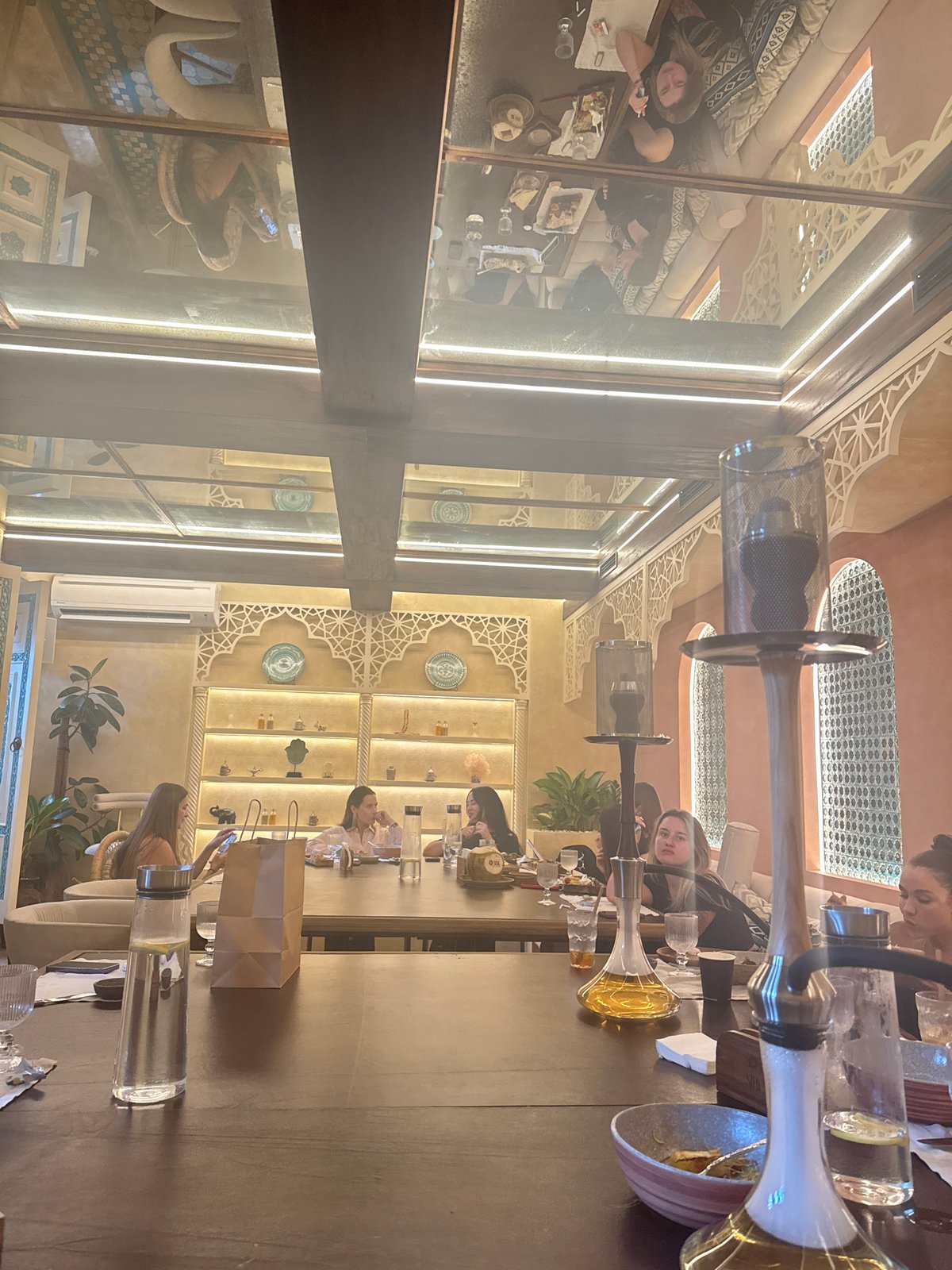 Restaurant scene captured in North Kuta with diners and hookah pipes