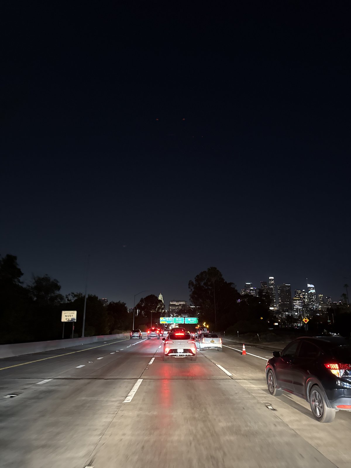 Early morning traffic observed on wet Los Angeles freeway