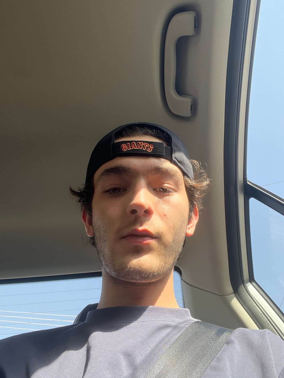 Man in Giants cap observed inside vehicle in Puebla