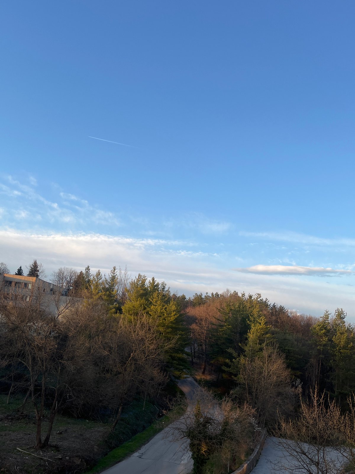 Aircraft contrail spotted over Gabrovo, Bulgaria hillside landscape