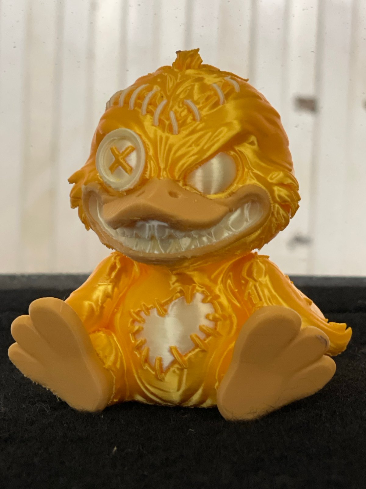 Yellow stitched bird figurine documented in Zelenograd studio shots