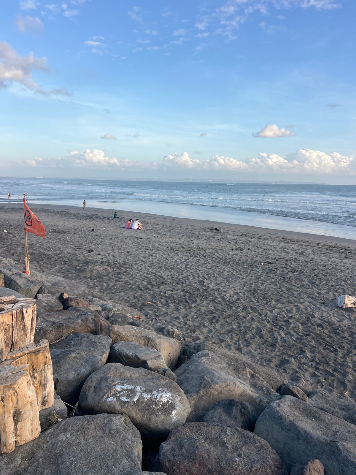 Bali's black sand beach buzzing with activity on a July morning