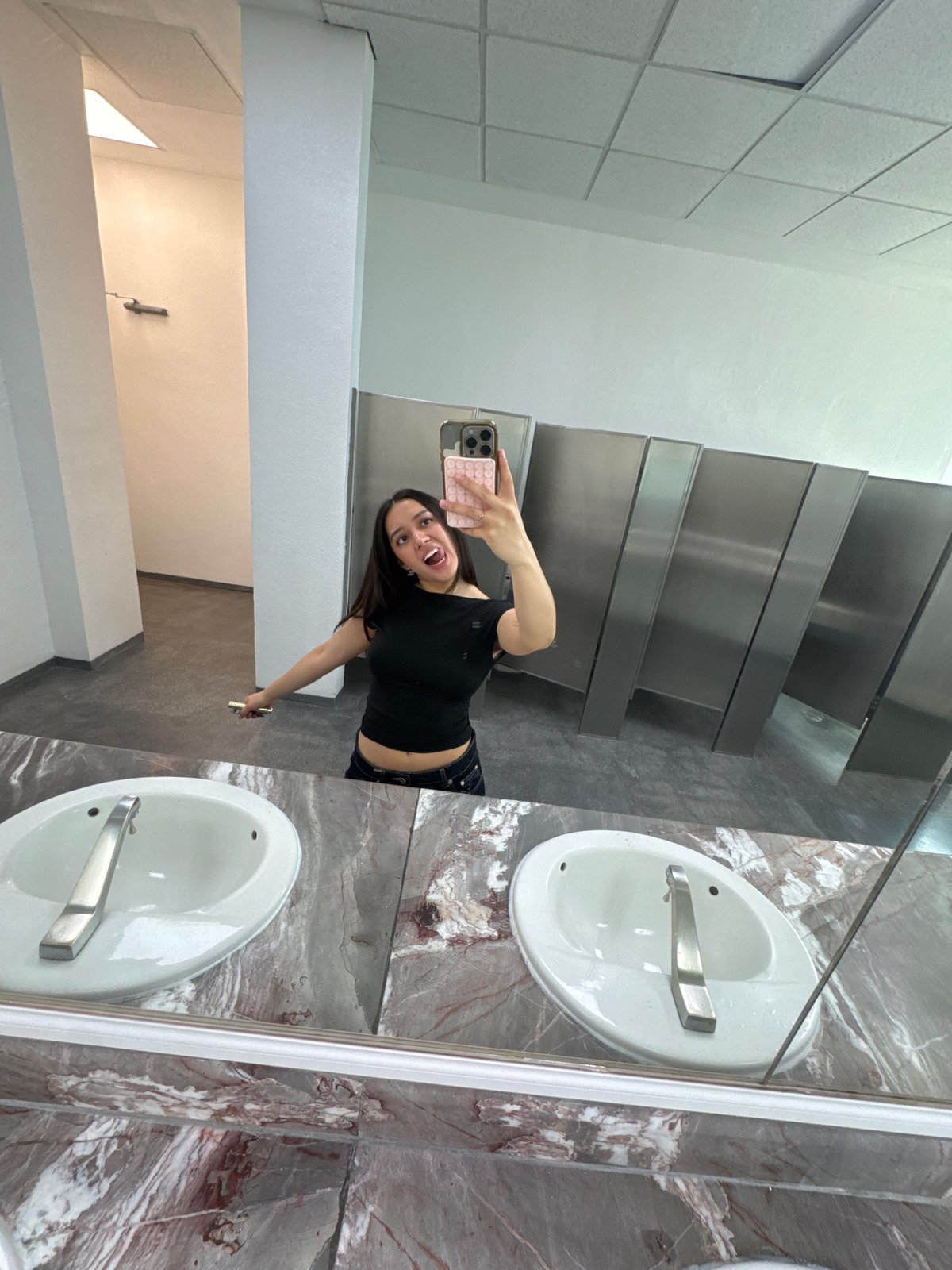 Woman takes selfies in Puebla restroom, area views captured