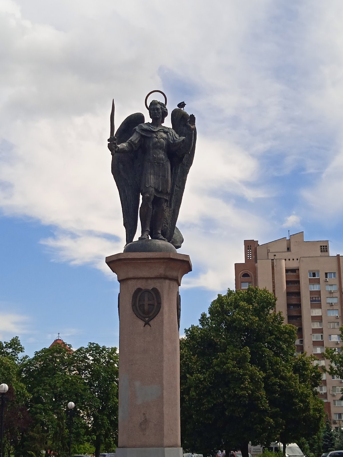 Urban stroll past monuments, flower beds, and residential towers