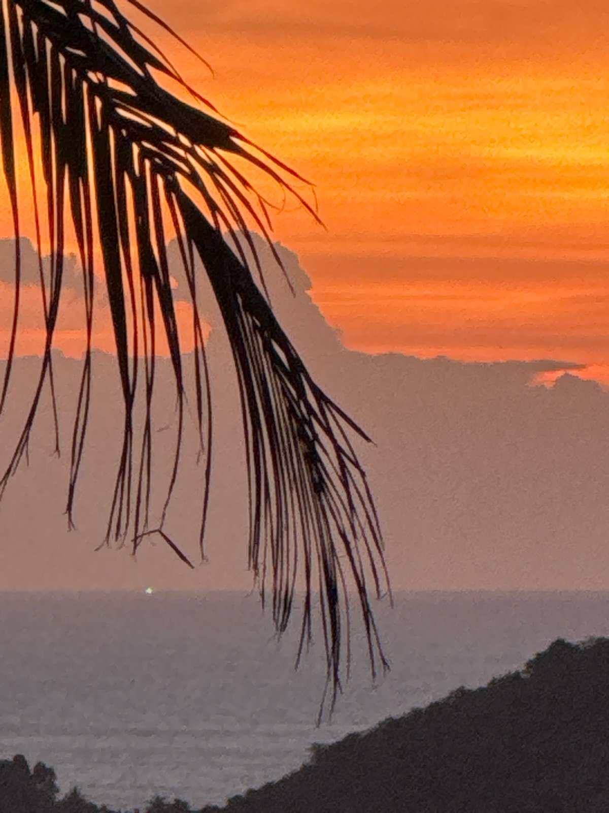 Tropical sunset captured over Thai coast and mountains