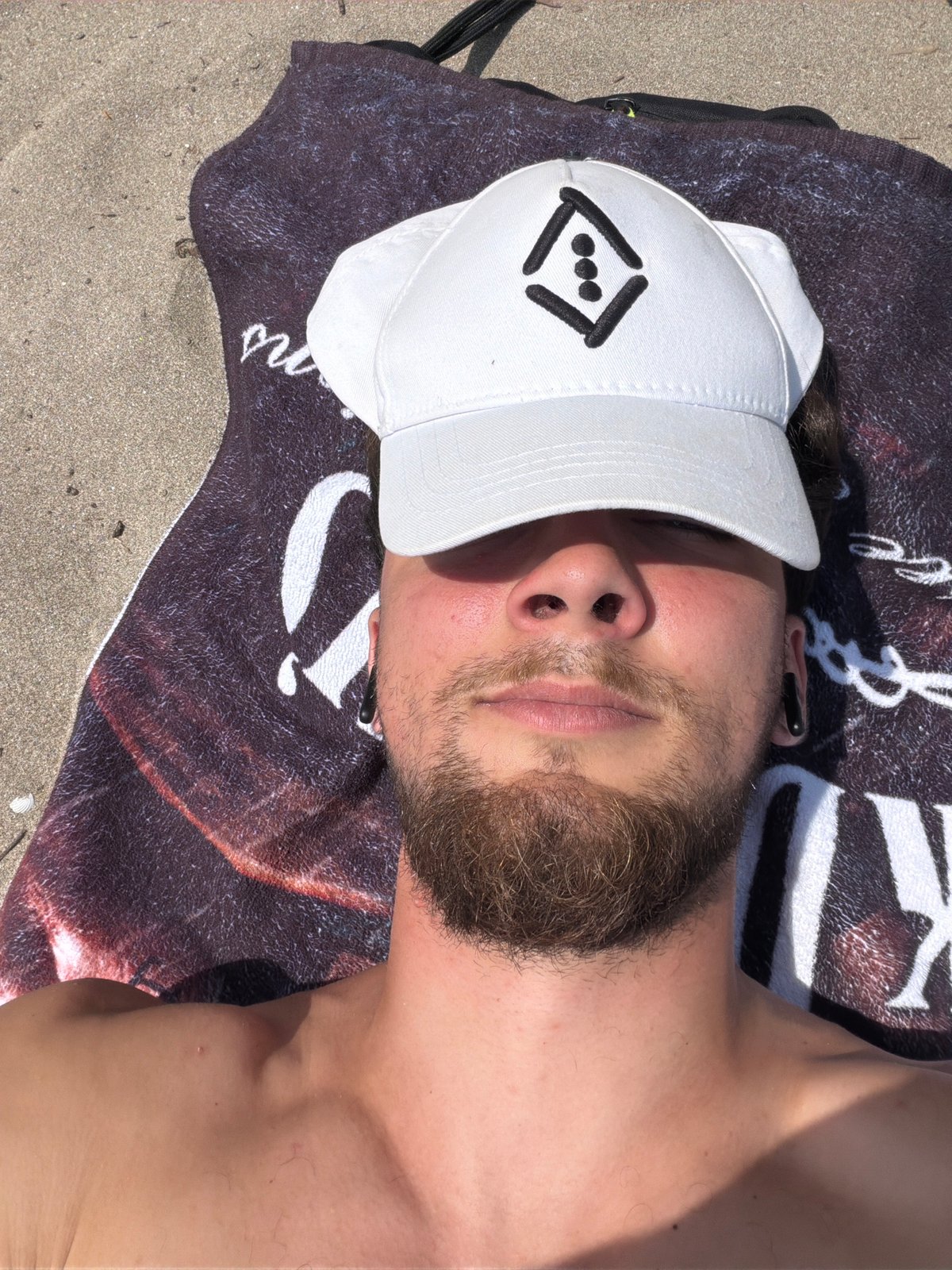 Man rests on beach in Tsarevo, Bulgaria