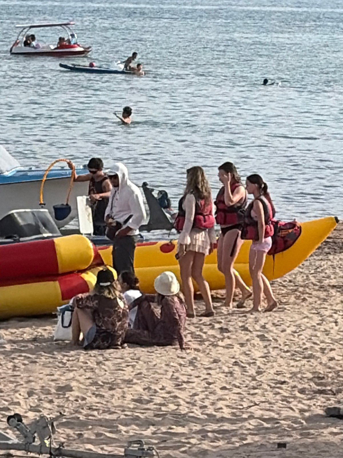 Full day of watersports and beach activity at a busy coastal spot