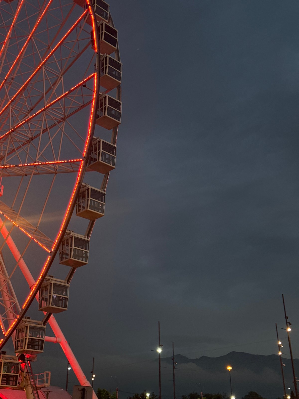 Rainy day mall trip ending at a lit-up Ferris wheel