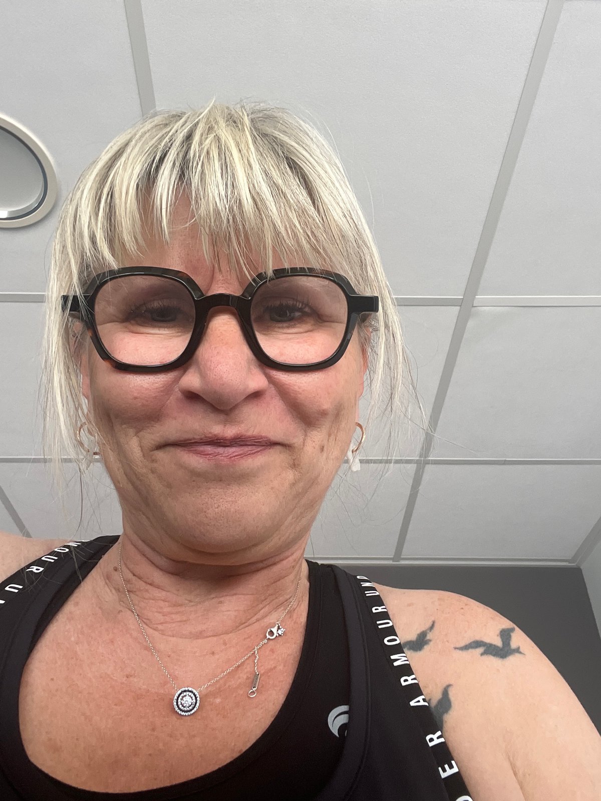 Tilted gym selfie captured in Saint-Galmier fitness center