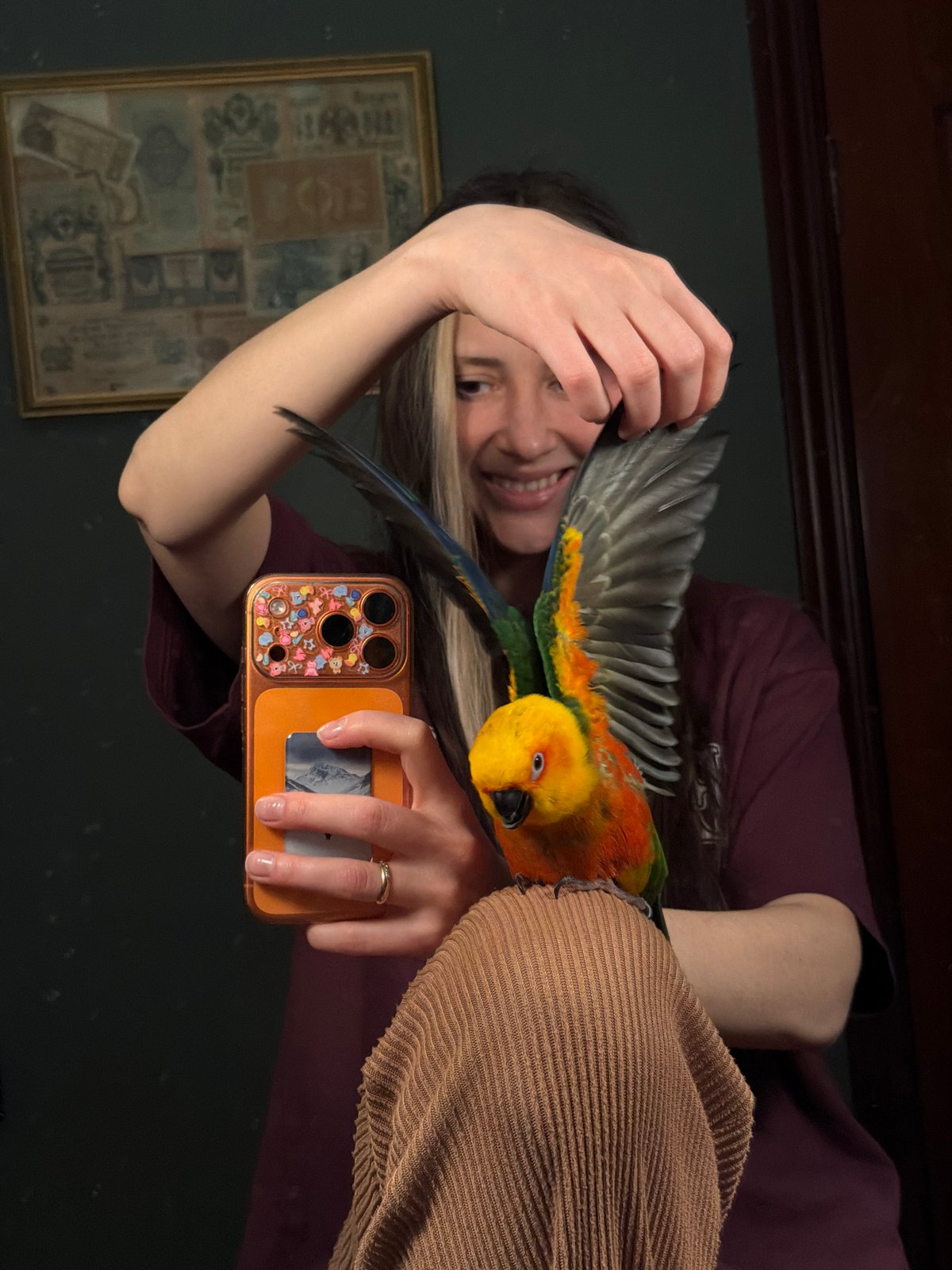 Woman takes selfie with colorful parrot in cheerful moment