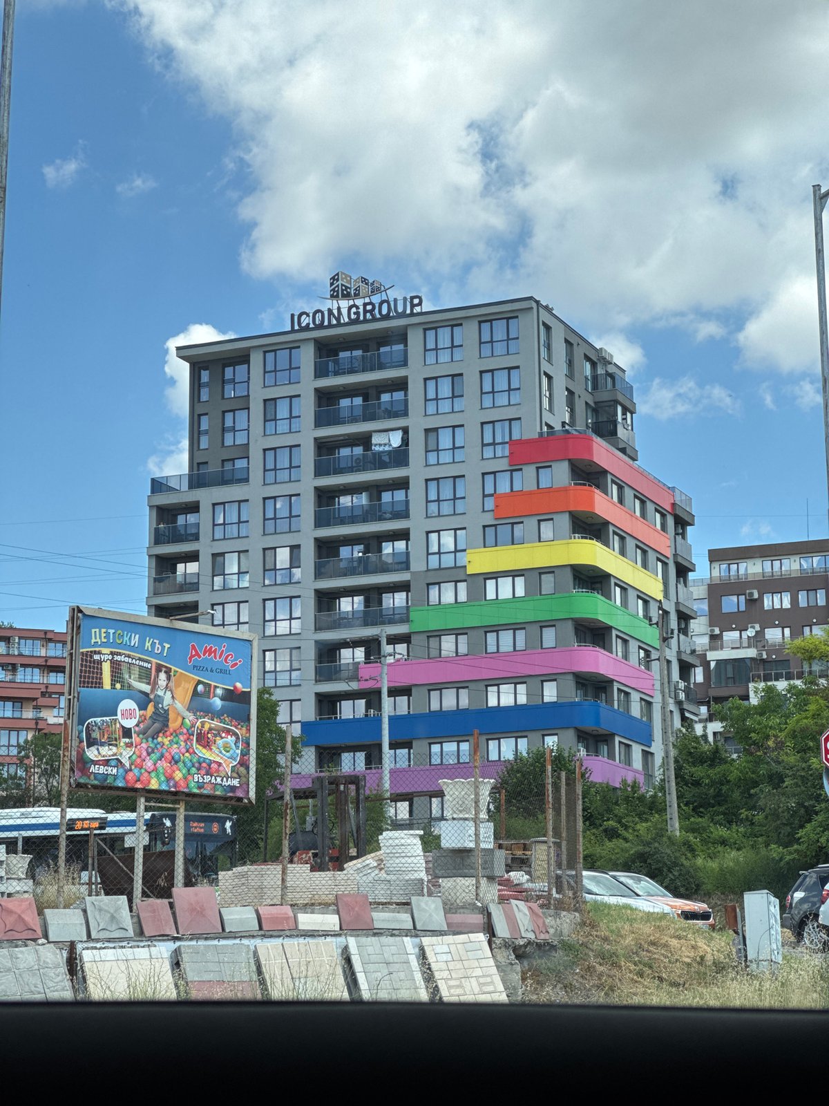Varna's colorful ICON GROUP tower and an abandoned car nearby