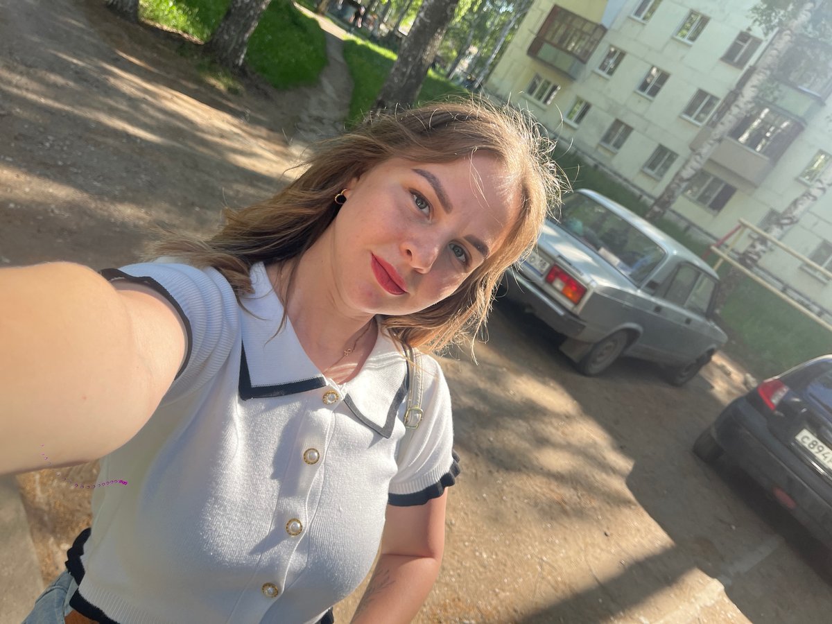 Woman photographs herself among birch trees in Izhevsk morning session