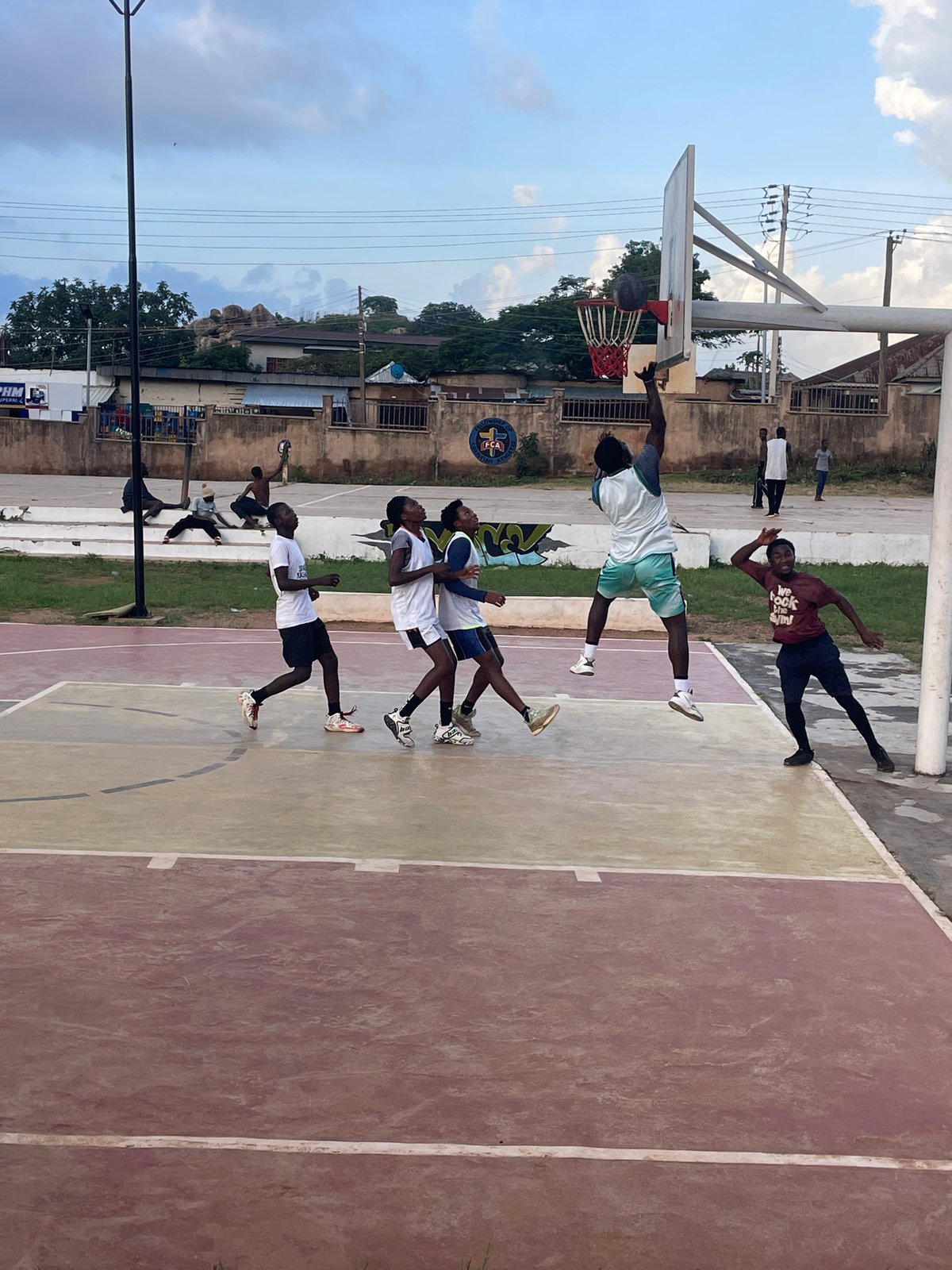 Pickup basketball in full swing at an outdoor court in Jos