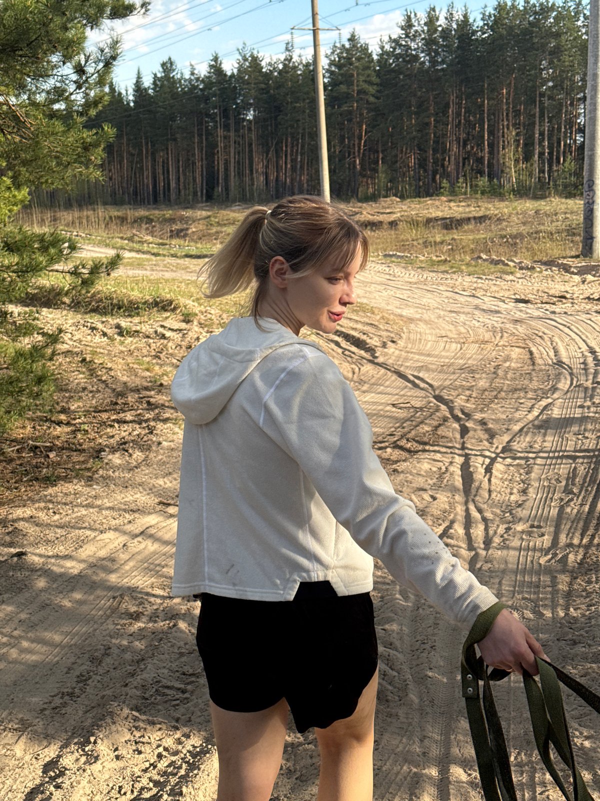 Woman walks dogs on dirt path in Nizhny Novgorod