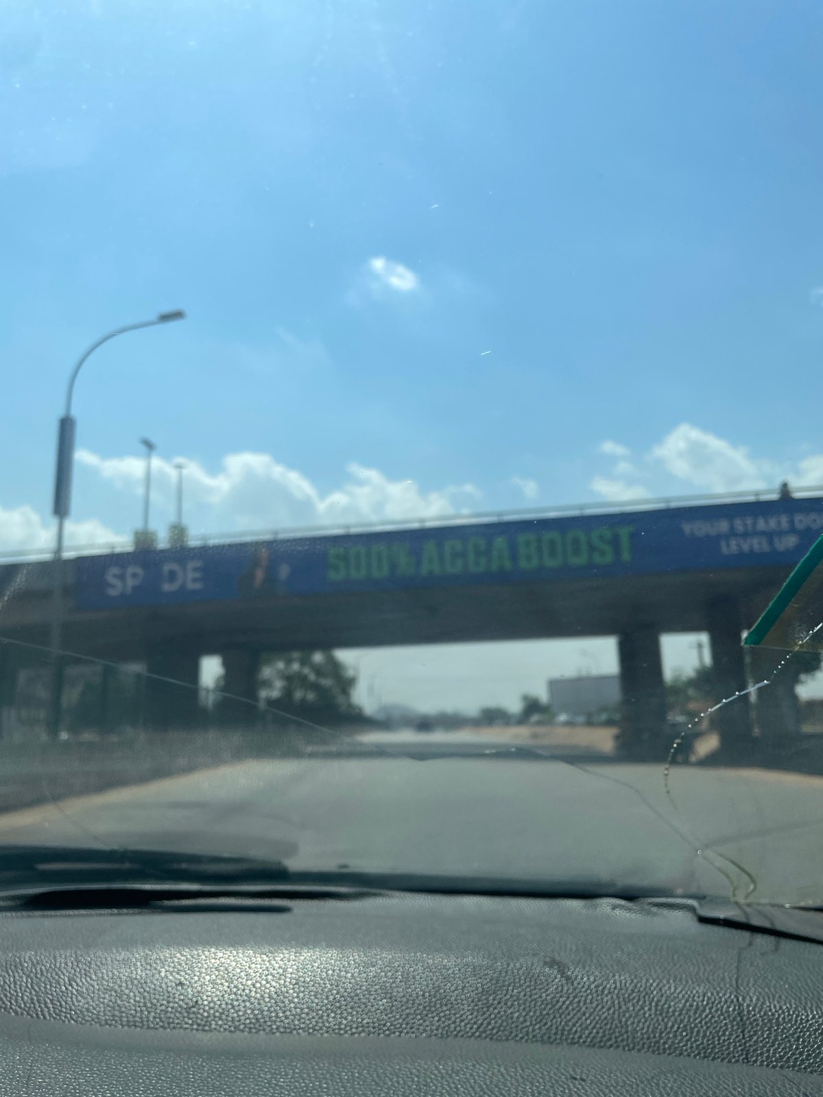 Vehicle occupant documents sky views through windshield in Abuja
