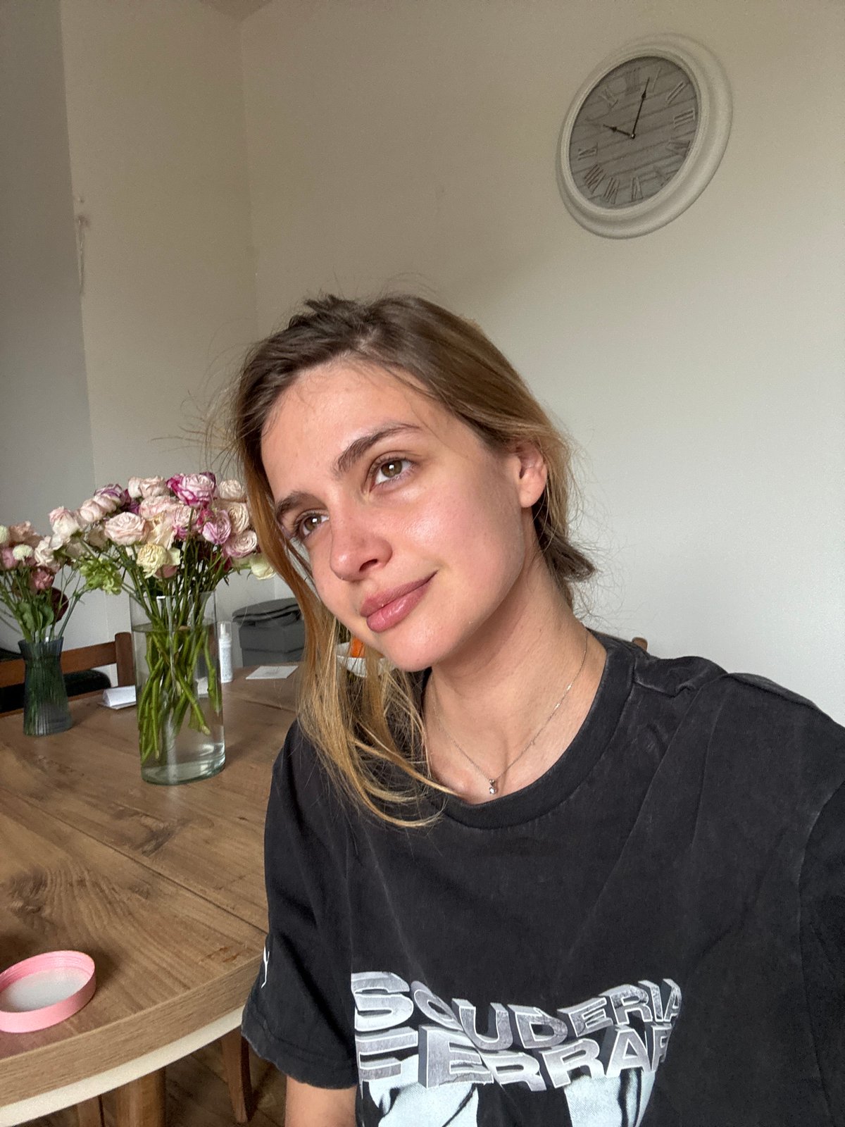 Woman applies skincare patch in home setting Saturday morning