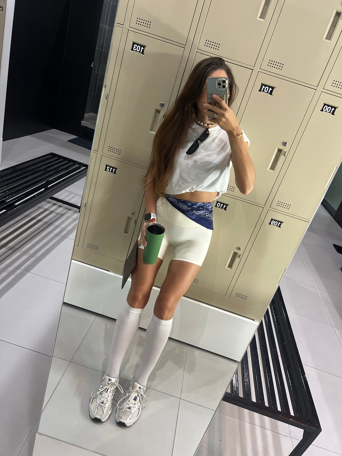 All-white gym outfit mirror selfie, locker room setting