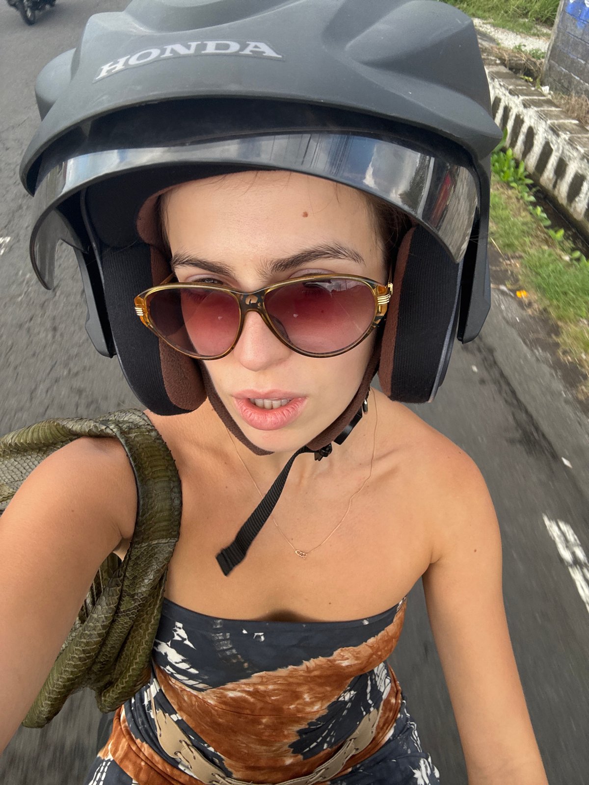 Motorcycle ride through Mengwi with a green snake in tow