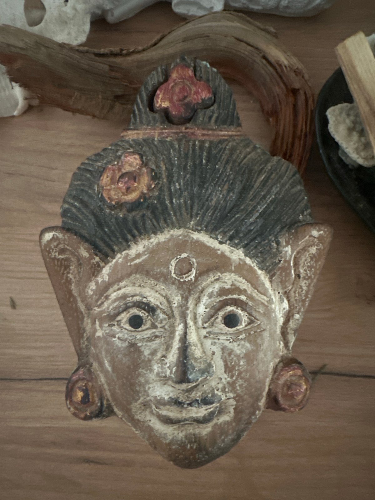 Ceremonial wooden mask and Buddha statue on display in Russia
