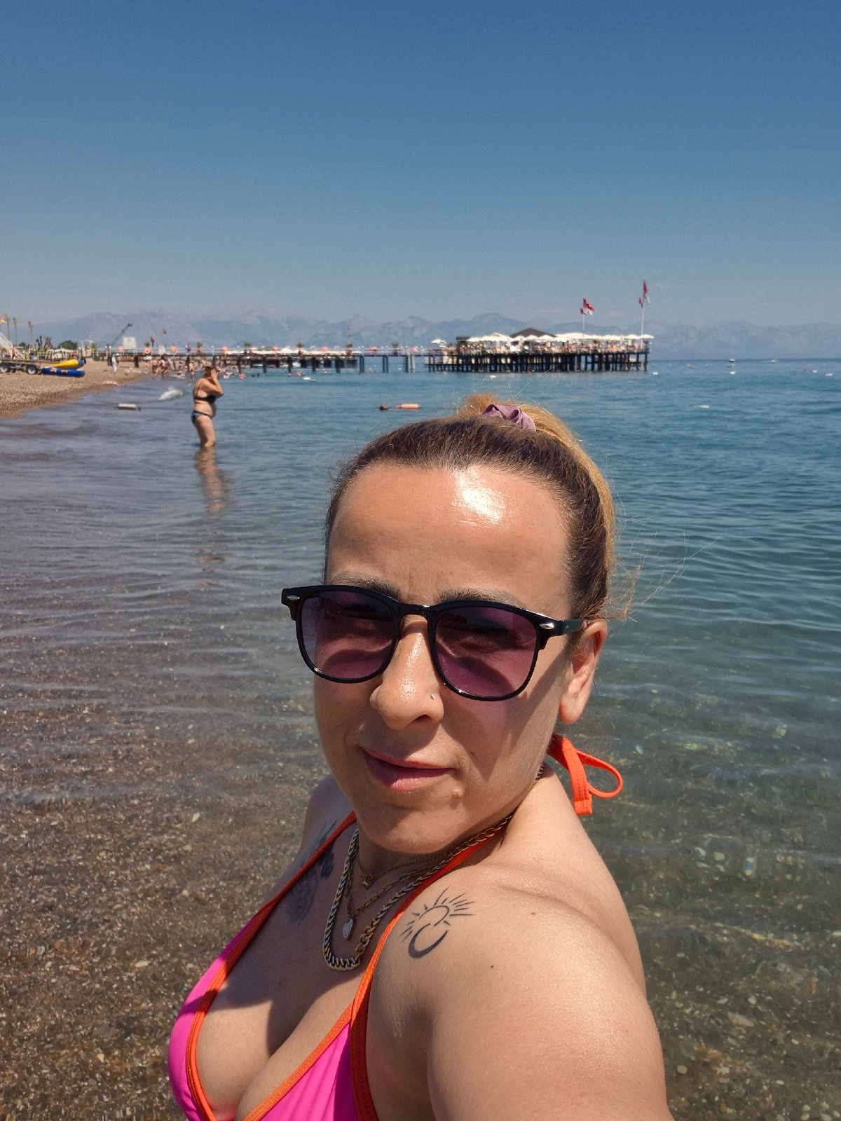 Sunny beach day with selfies, loungers, and shoreline scenes