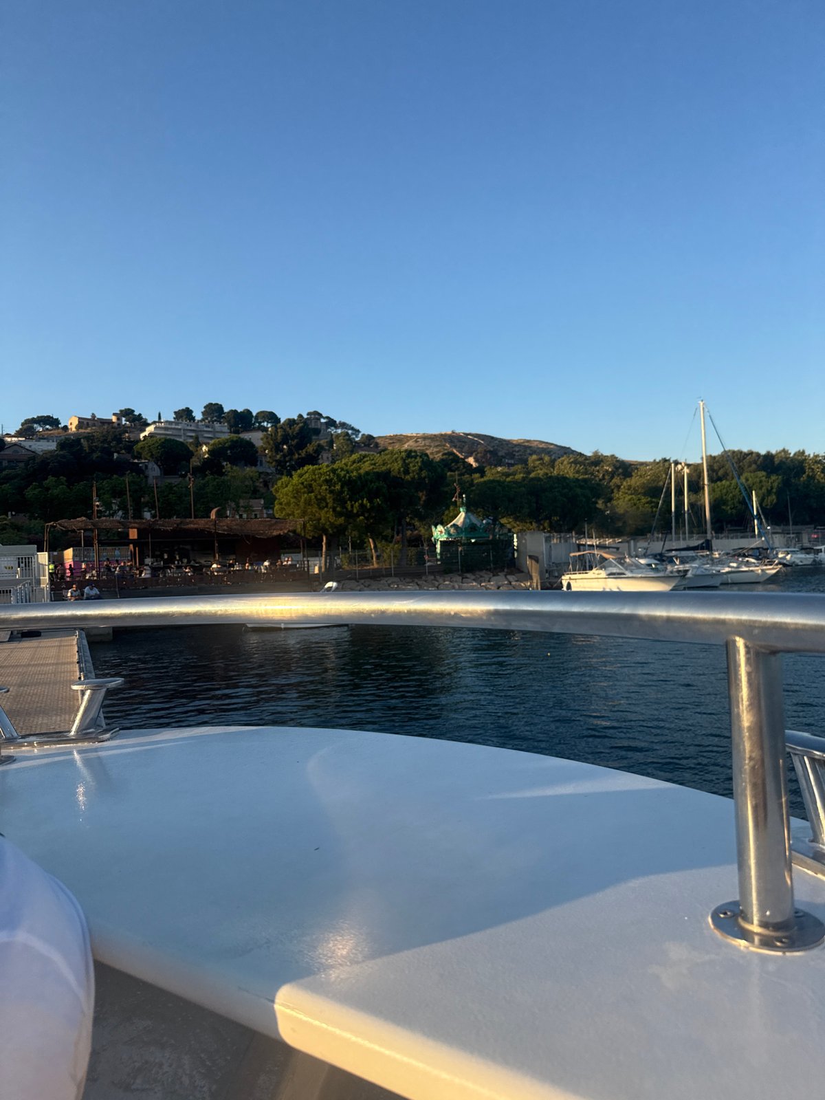Boat ride through calm harbor waters on a sunny afternoon