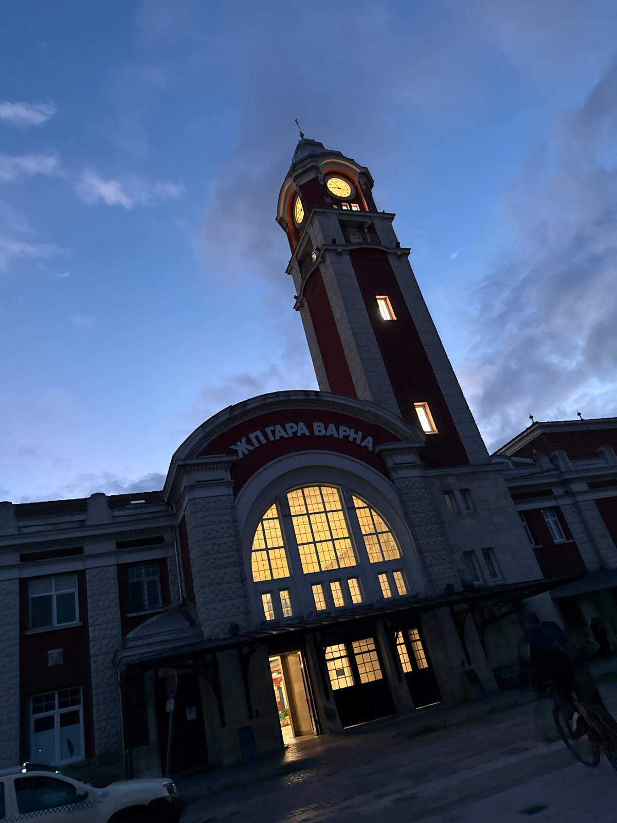 Evening urban scenes captured: clock tower, cityscape, illuminated Ferris wheel