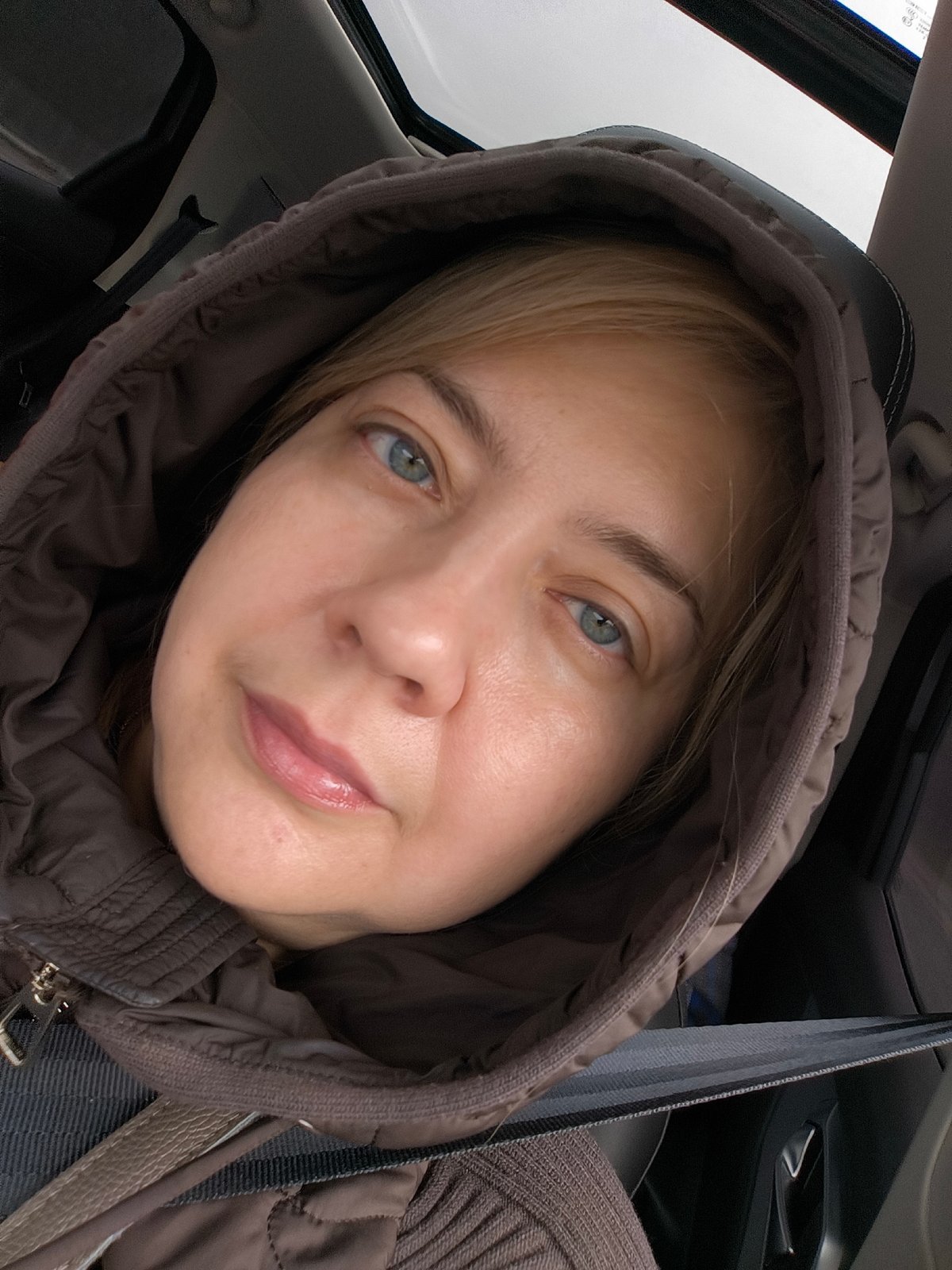 Driver documents rainy highway journey with selfie, construction observed