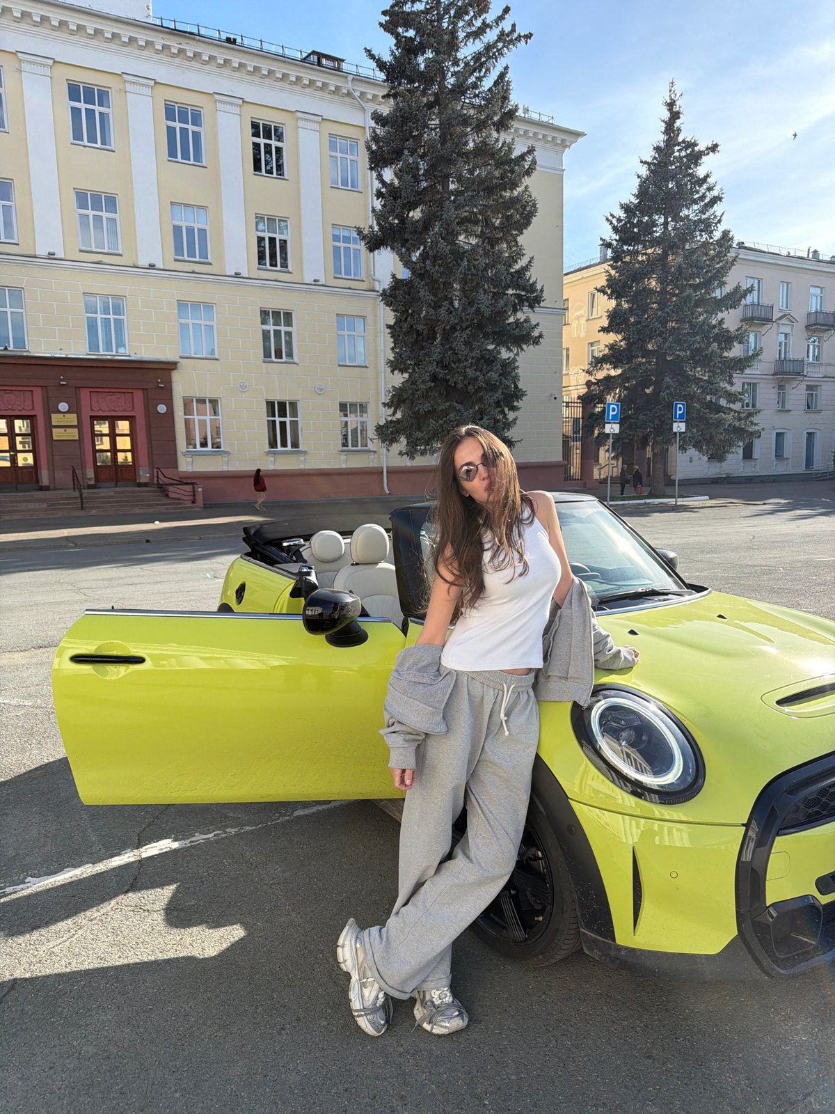 Couple poses with yellow Mini Cooper in Zheleznogorsk
