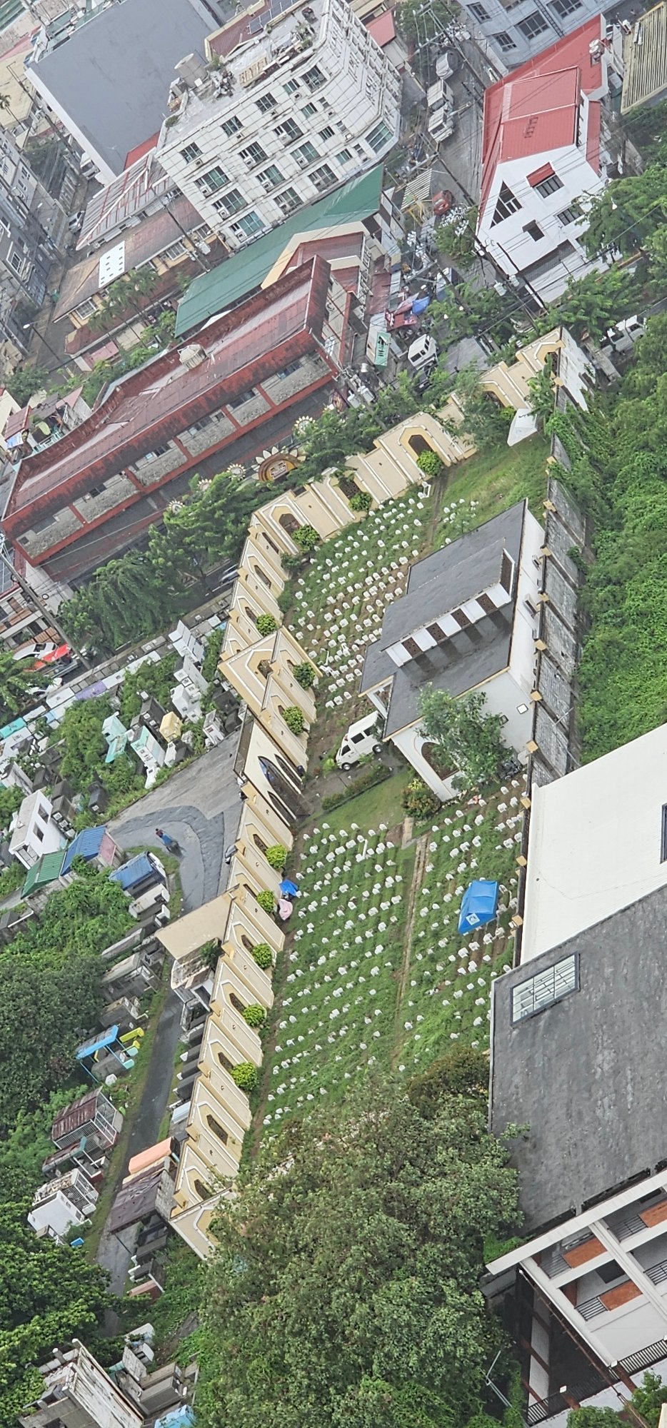 Aerial sweep of Makati's skyline and Manila Memorial Park