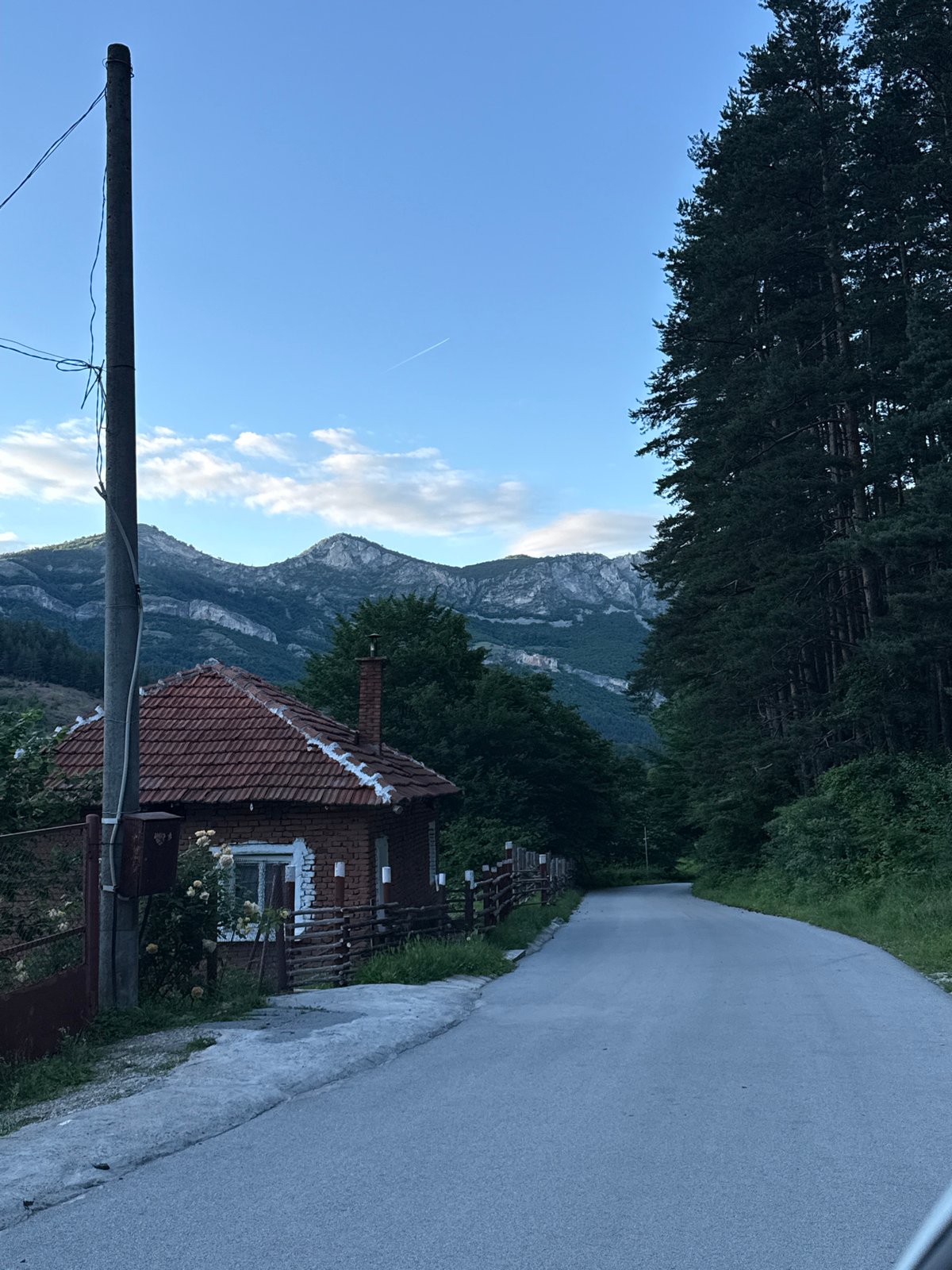 Rural road curves through mountainous Zgorigrad at dusk