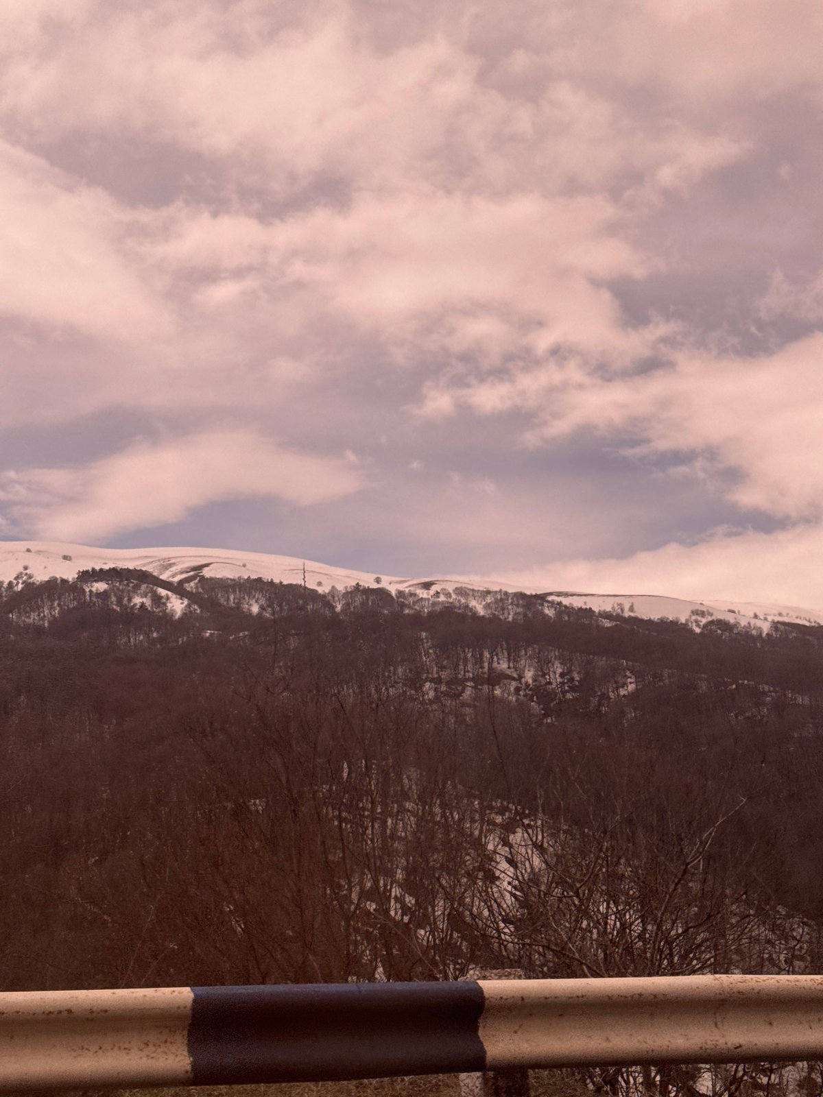 Snow-covered mountains viewed from Tsovagyugh, Armenia under cloudy skies