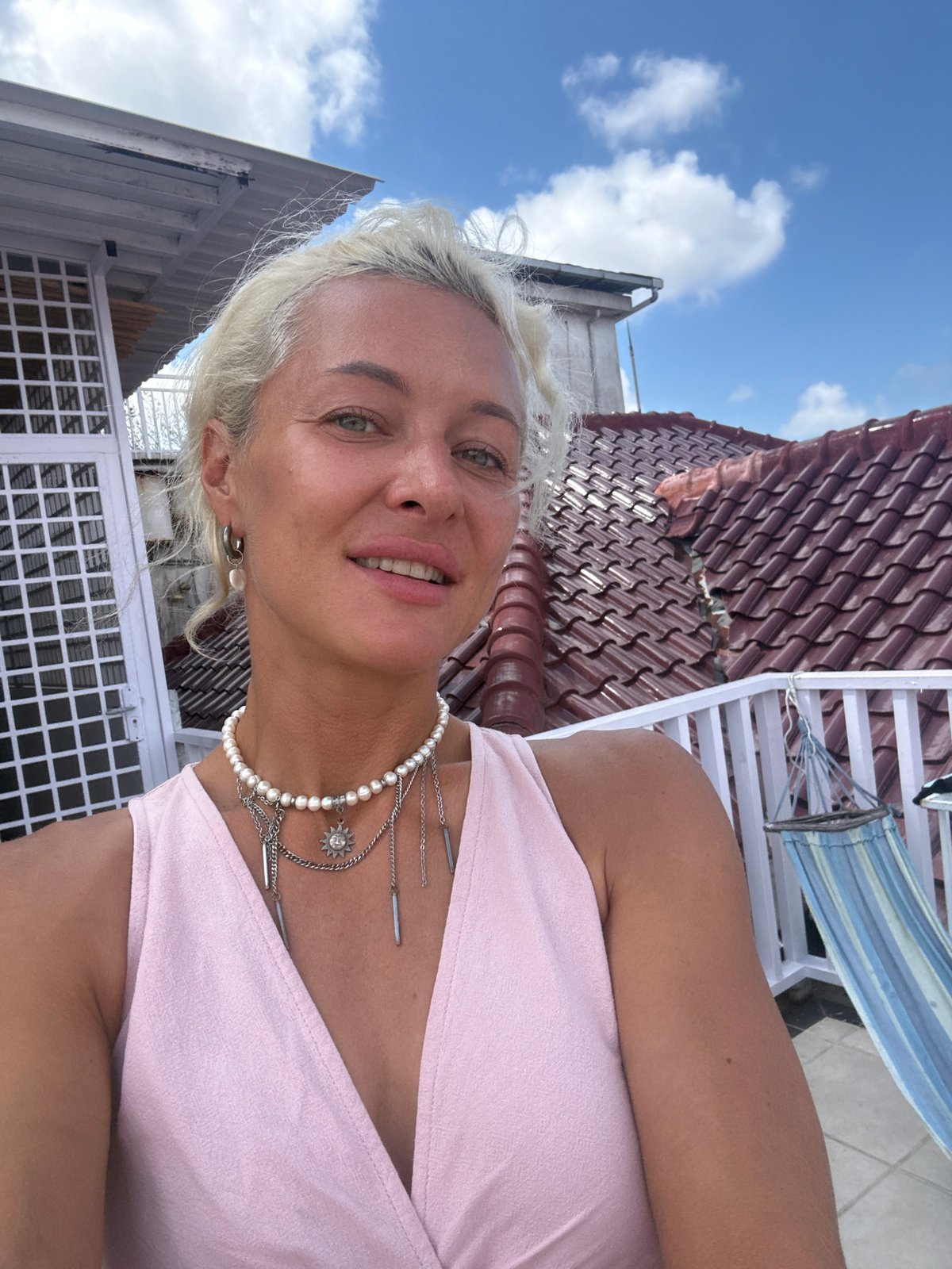 Woman takes selfie on balcony in early morning