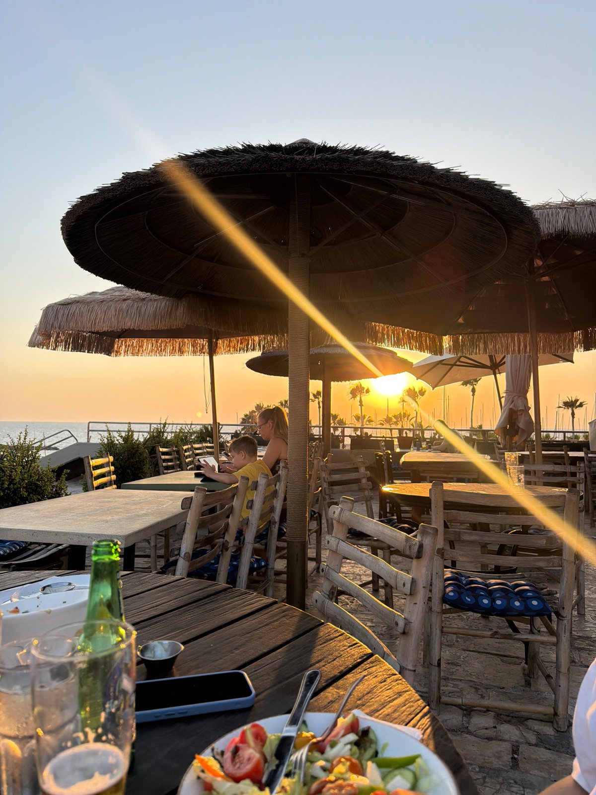 Tel Aviv beachfront at golden hour, August 2026