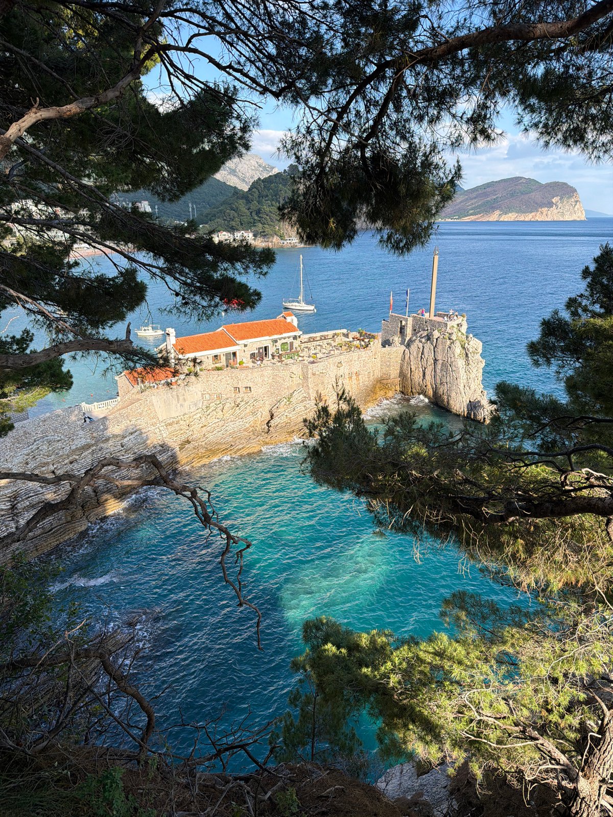 Coastal views and vehicle towing documented in Petrovac, Montenegro