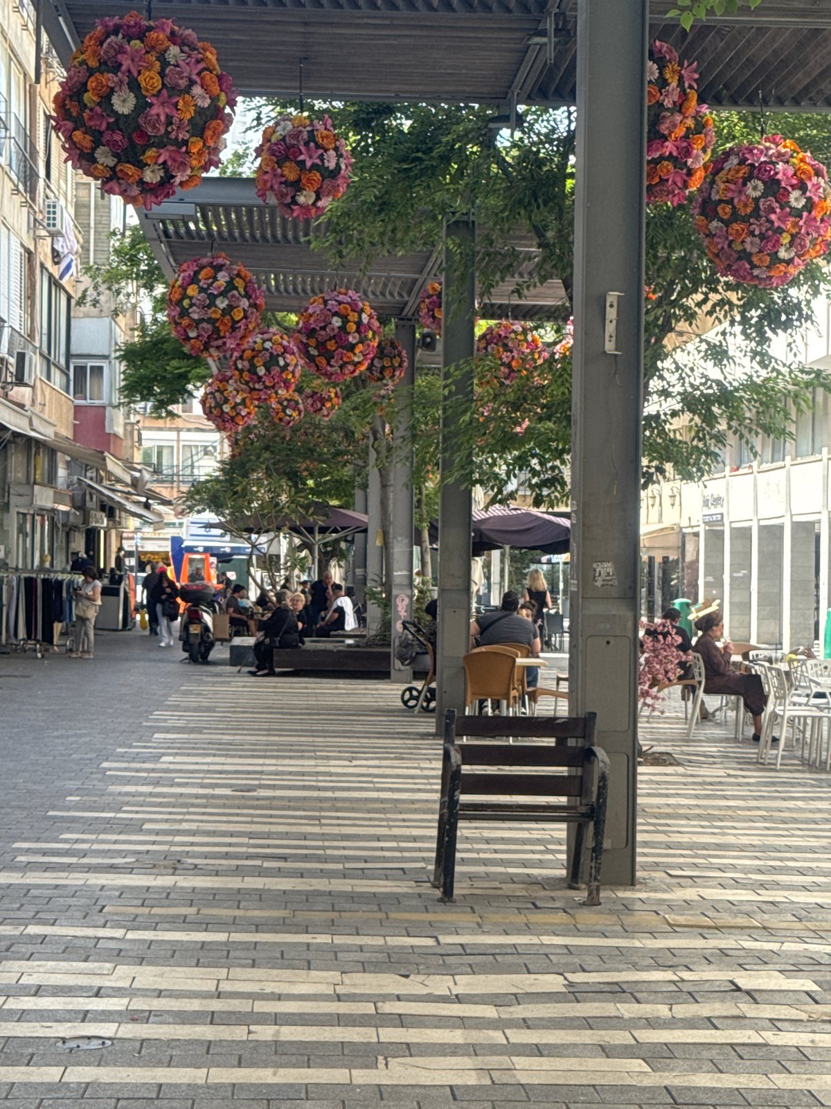 Pedestrian shopping street observed in Netanya with outdoor dining