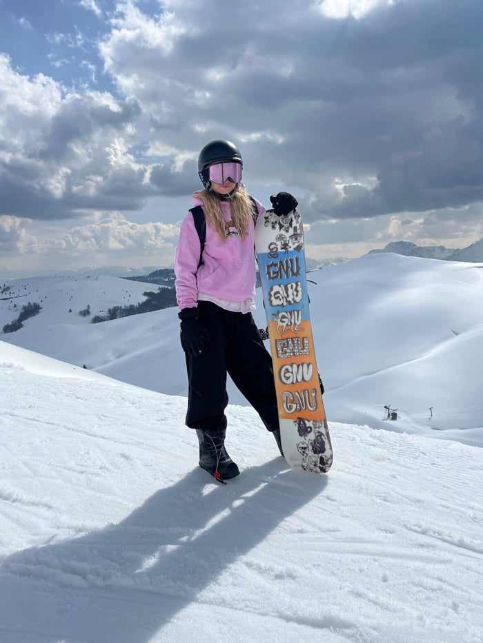 Snowboarder documented at Montenegro ski resort during sunny mountain day
