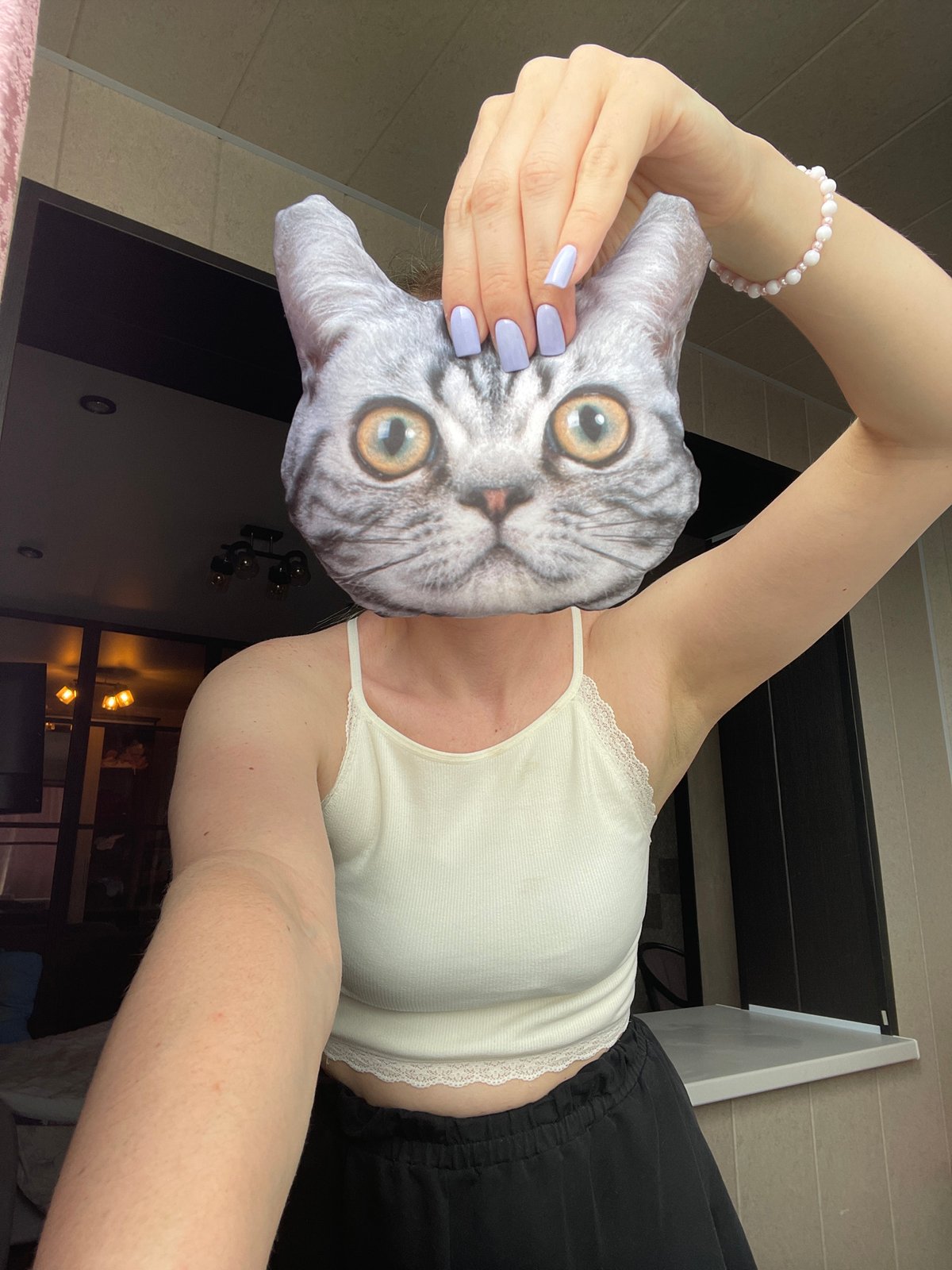Person poses with cat pillow in Vladivostok