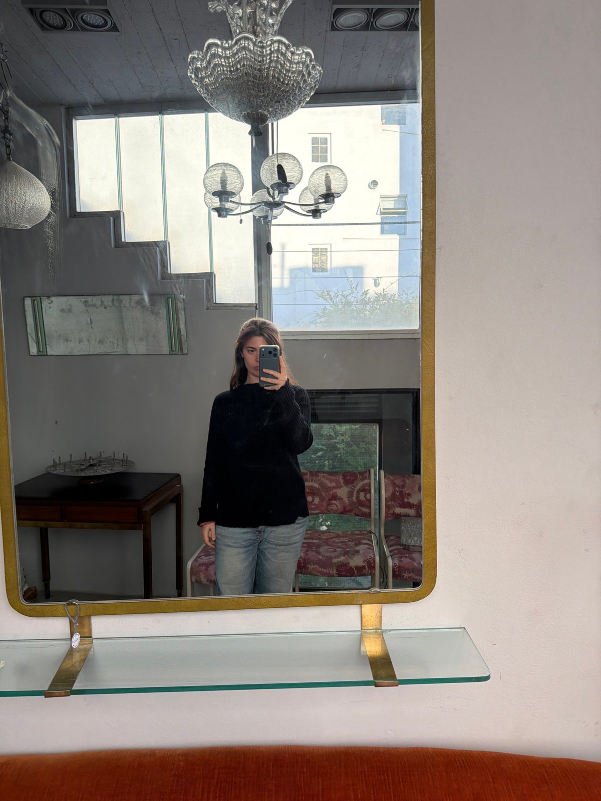 Woman takes mirror selfies in Buenos Aires vintage showroom