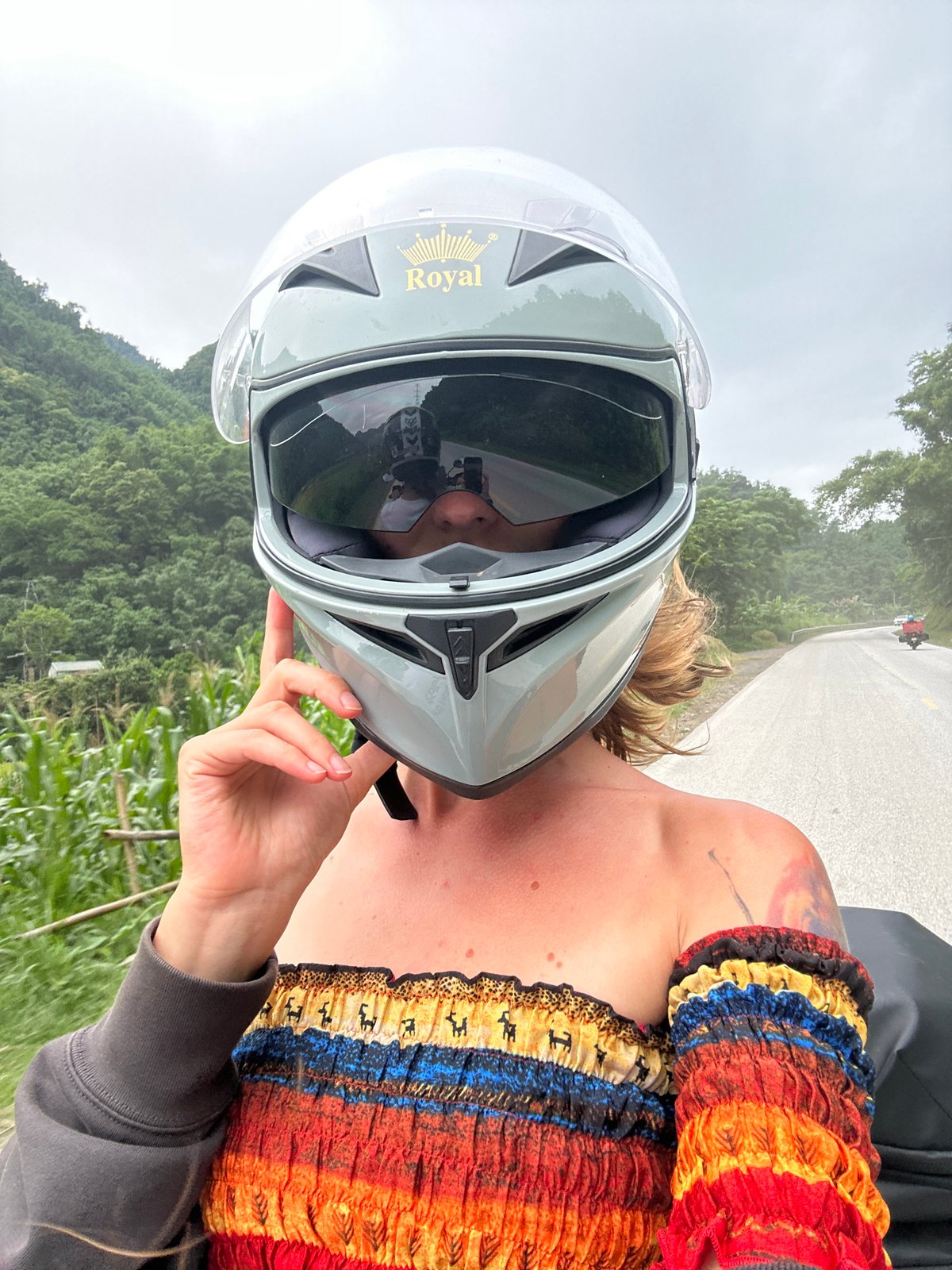 Motorcyclist takes selfies in colorful dress in Vietnam