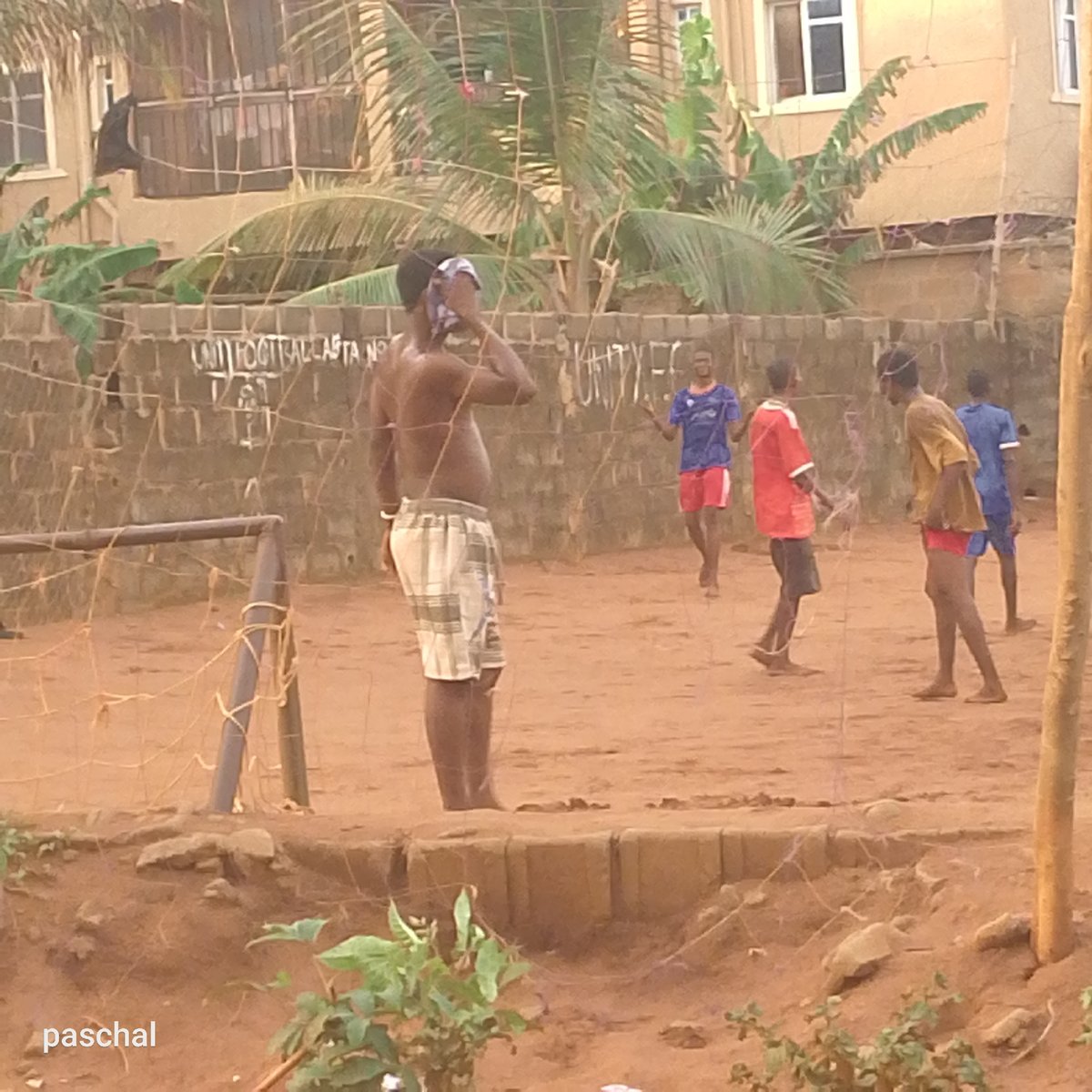 Informal soccer game played on dirt field in Nigeria