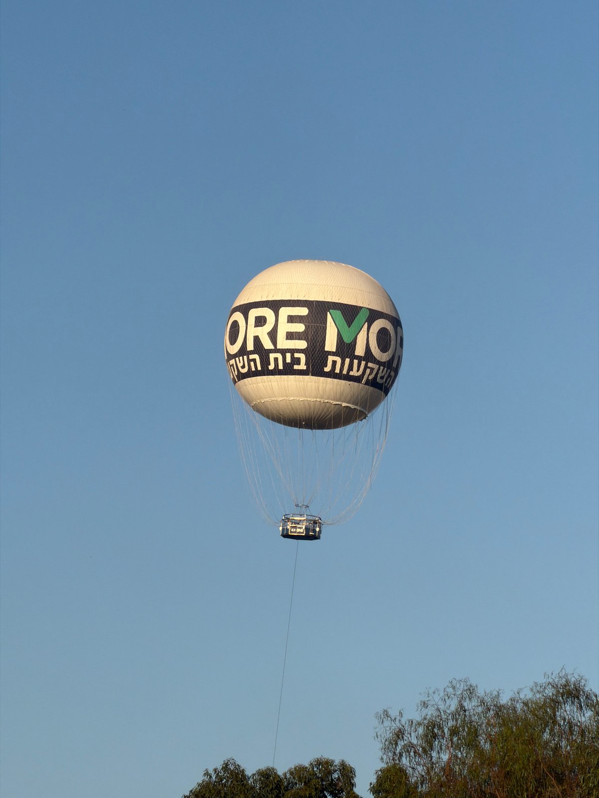 Branded hot air balloon drifts over Tel Aviv skies