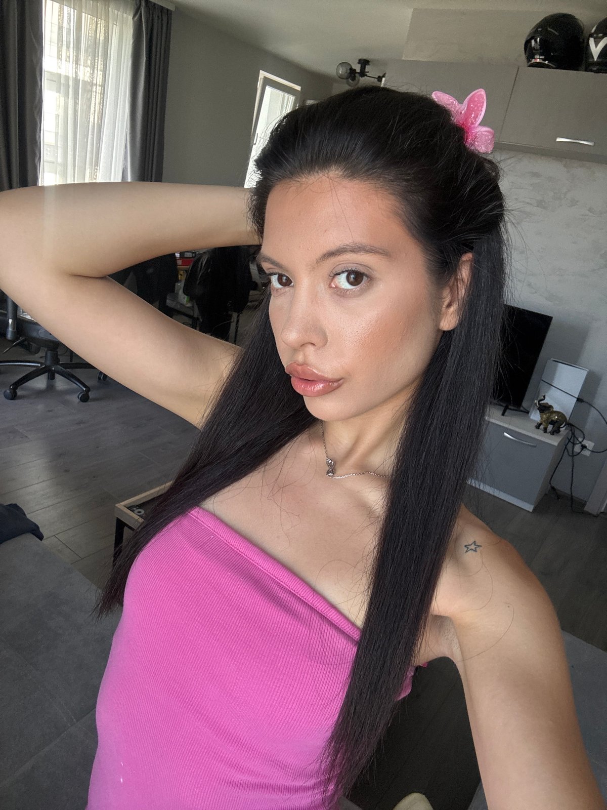 Indoor selfie moment in a Sofia apartment, pink butterfly clip.