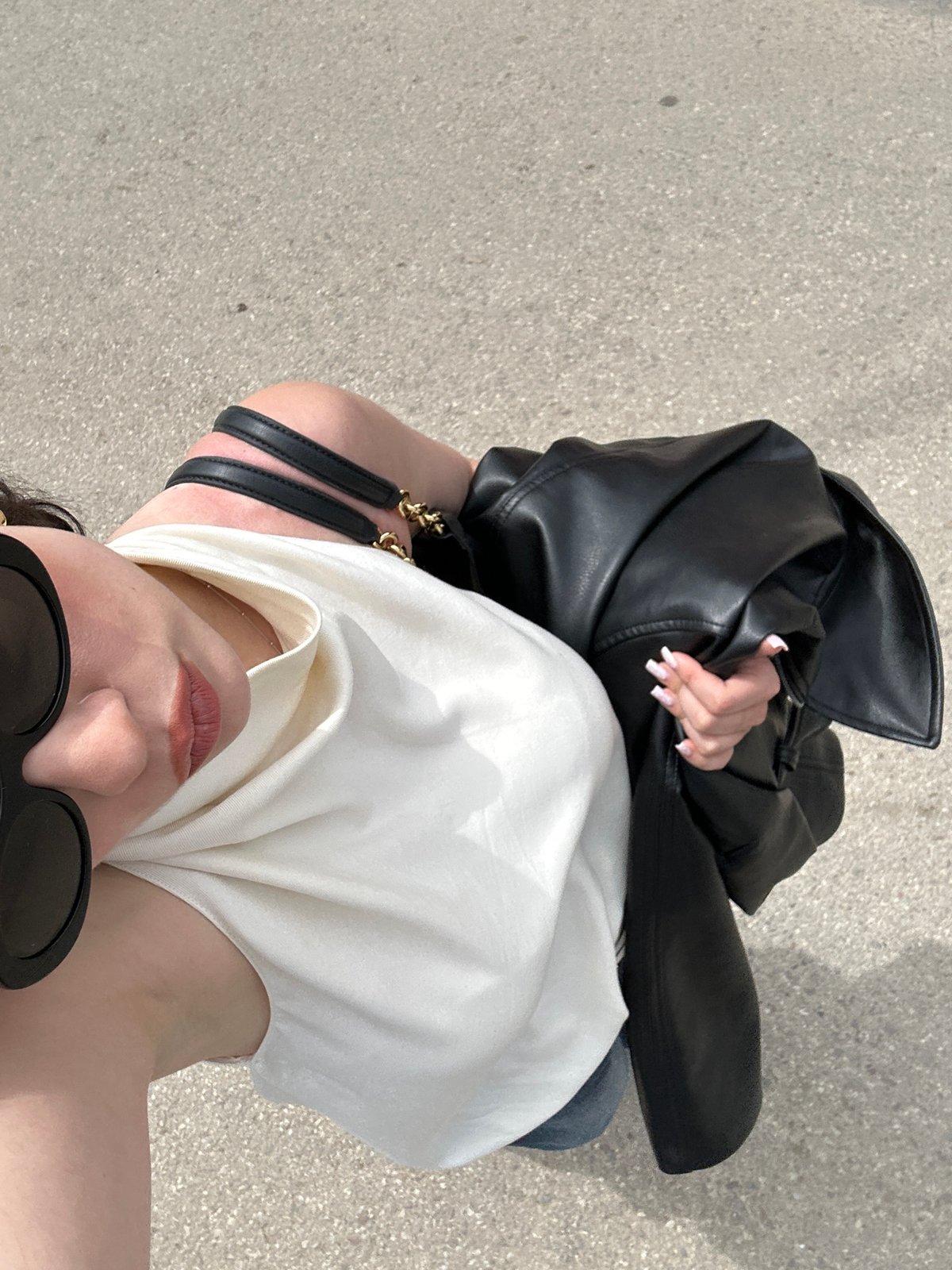 Person photographed with leather jacket near striped building in Sofia