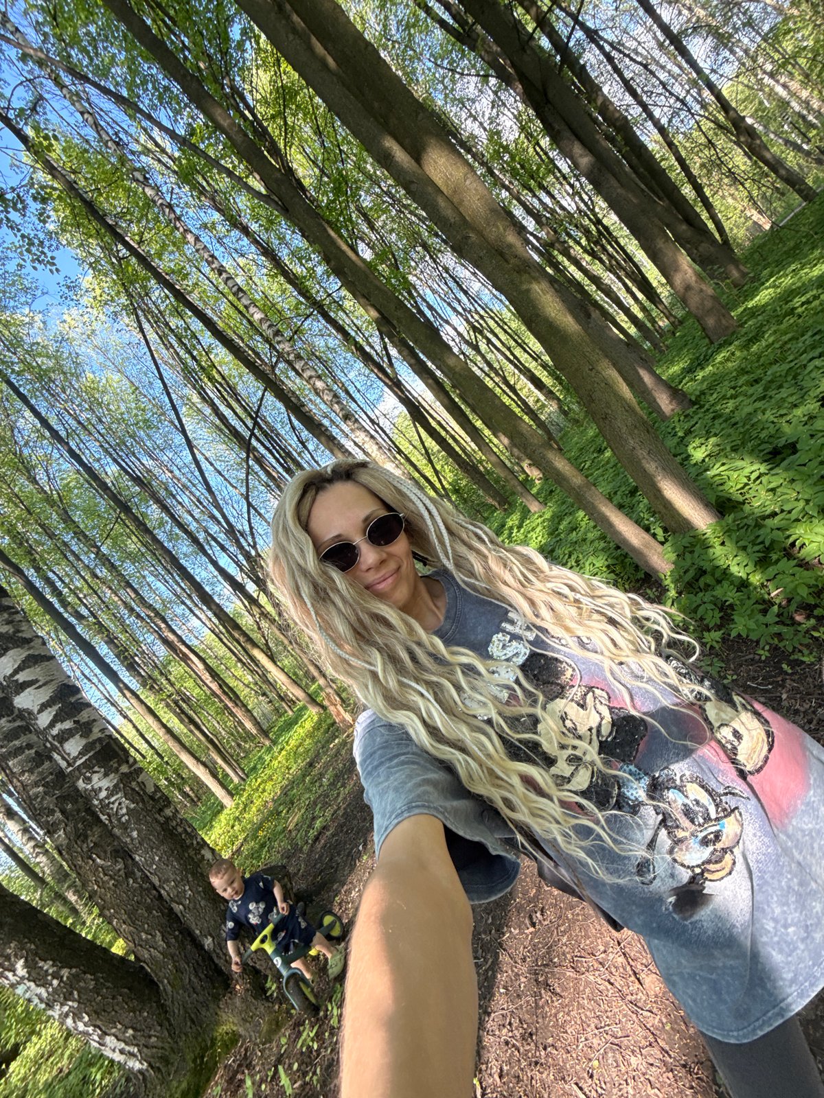 Mother and child enjoy afternoon forest outing near Rusanovo