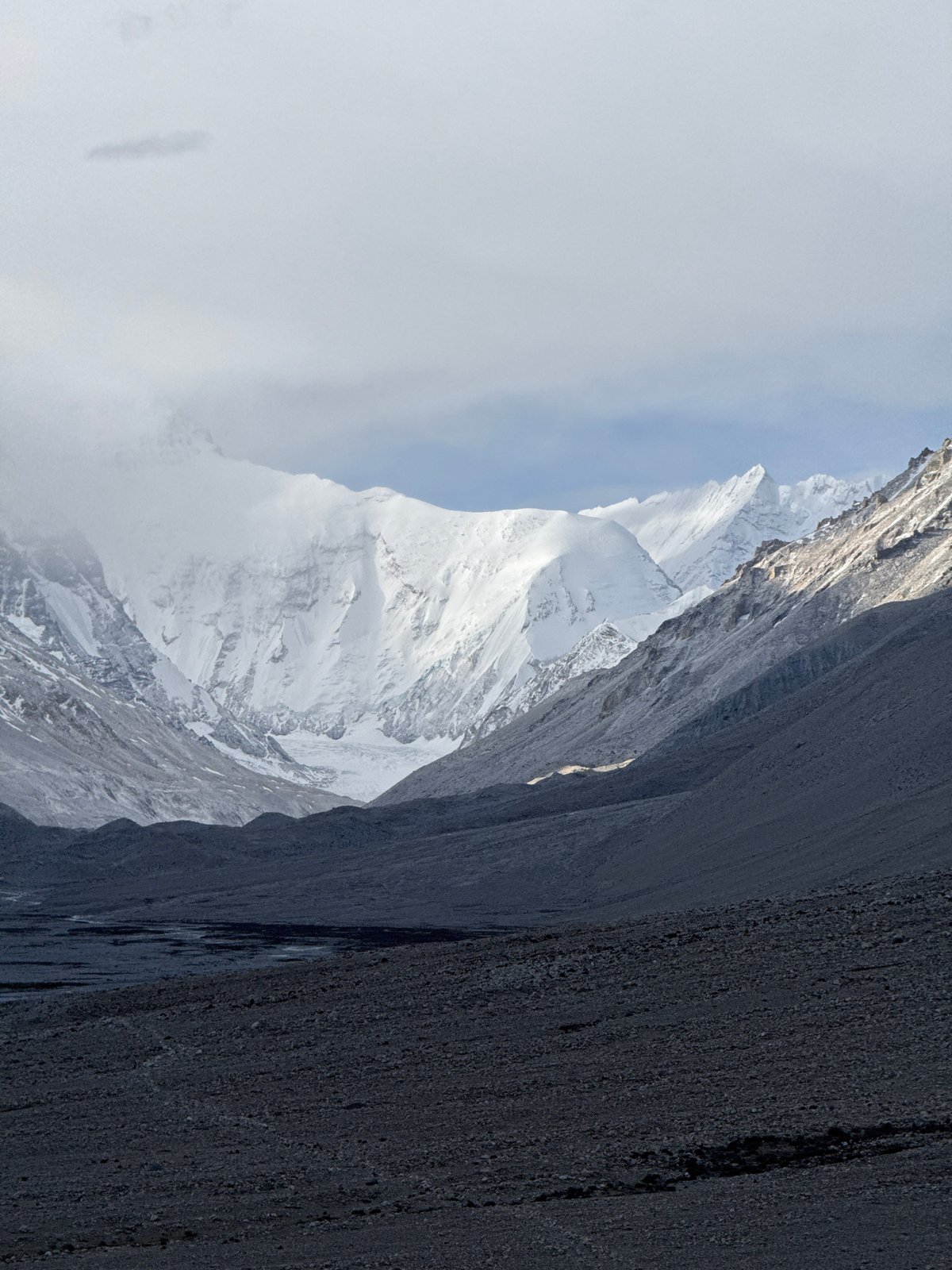 Snow-capped mountains observed through clouds in Tashi Dzom, China