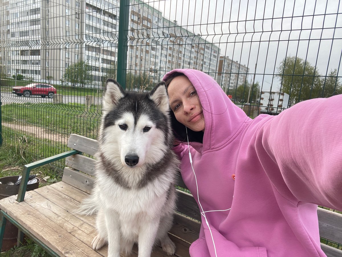 Woman and husky share quiet moment on bench in Izhevsk