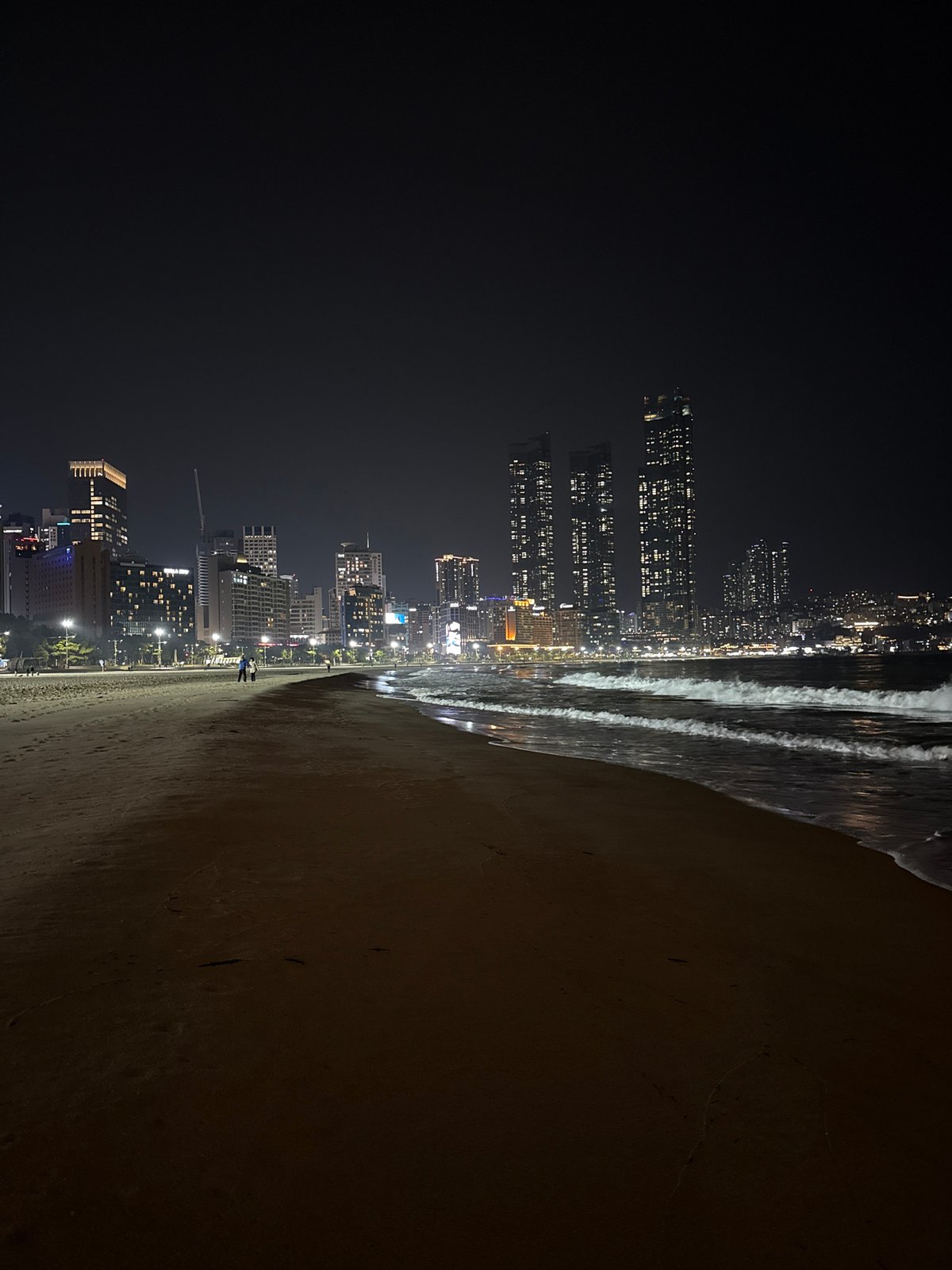 Nighttime scenes captured across Busan beaches and streets