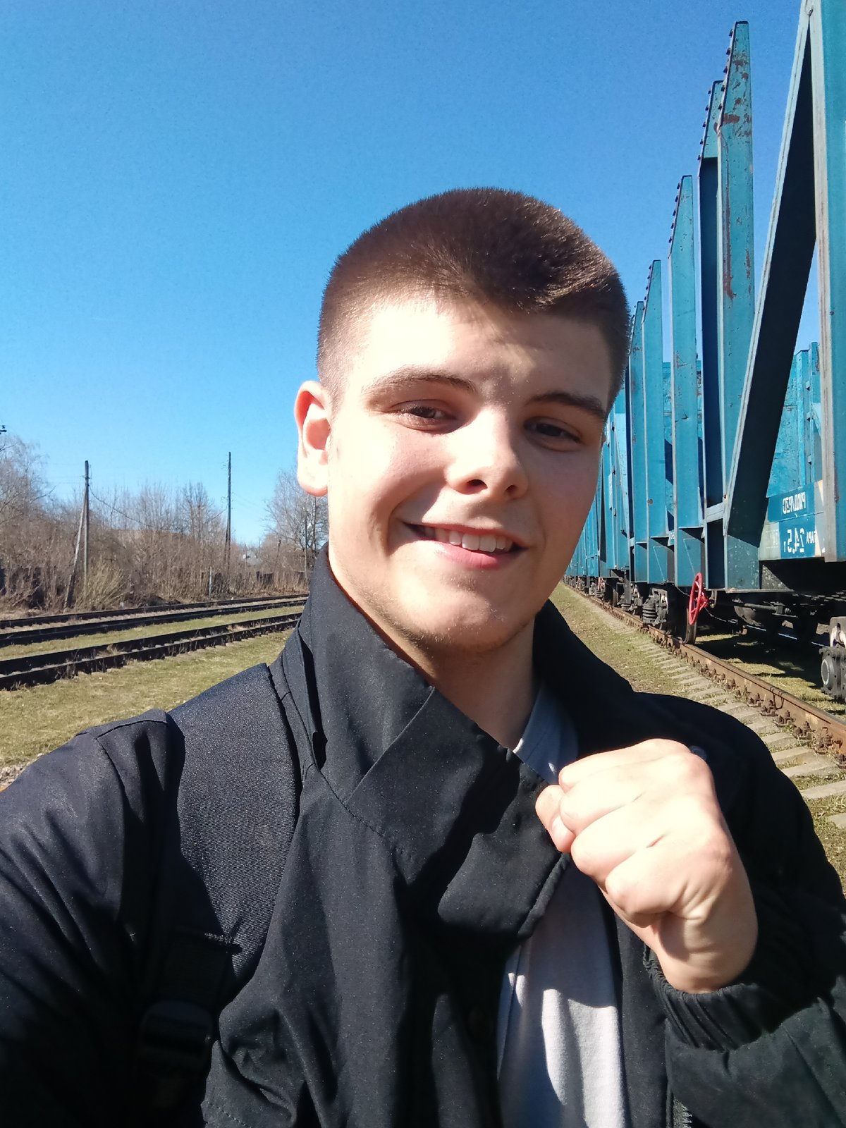 Young man takes selfies by freight train in Andreyevo